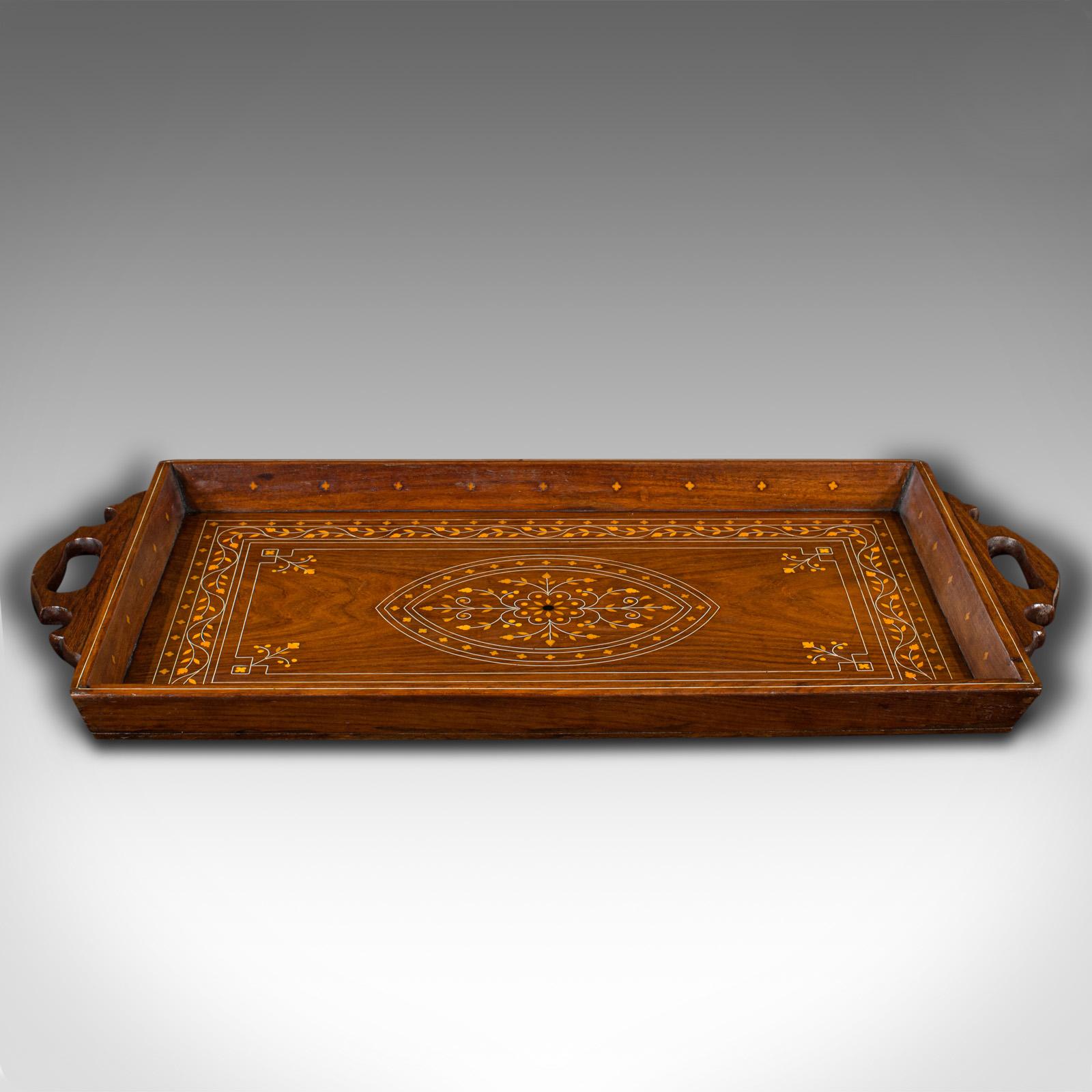 This is a vintage inlaid serving tray. An English, walnut and boxwood afternoon tea slide, dating to the late Art Deco period, circa 1940.

Strikingly inlaid tray with decorative appeal
Displaying a desirable aged patina and in good order
Select