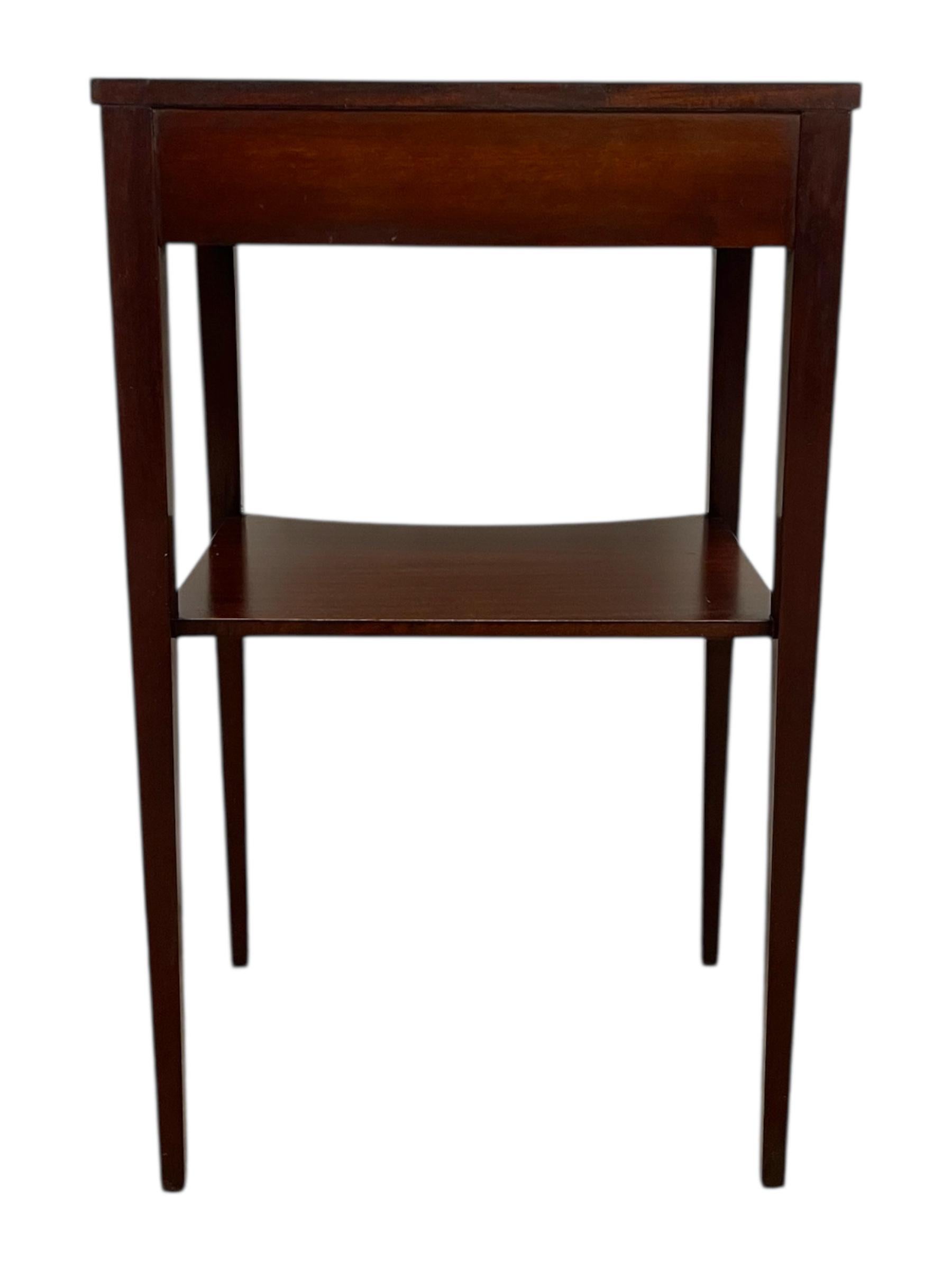 This vintage side table features elegant proportions, clean lines, and classic inlaid detailing throughout. The top surface is framed with fine line inlays that highlight the grain and provide a refined decorative border. Coordinating inlay work