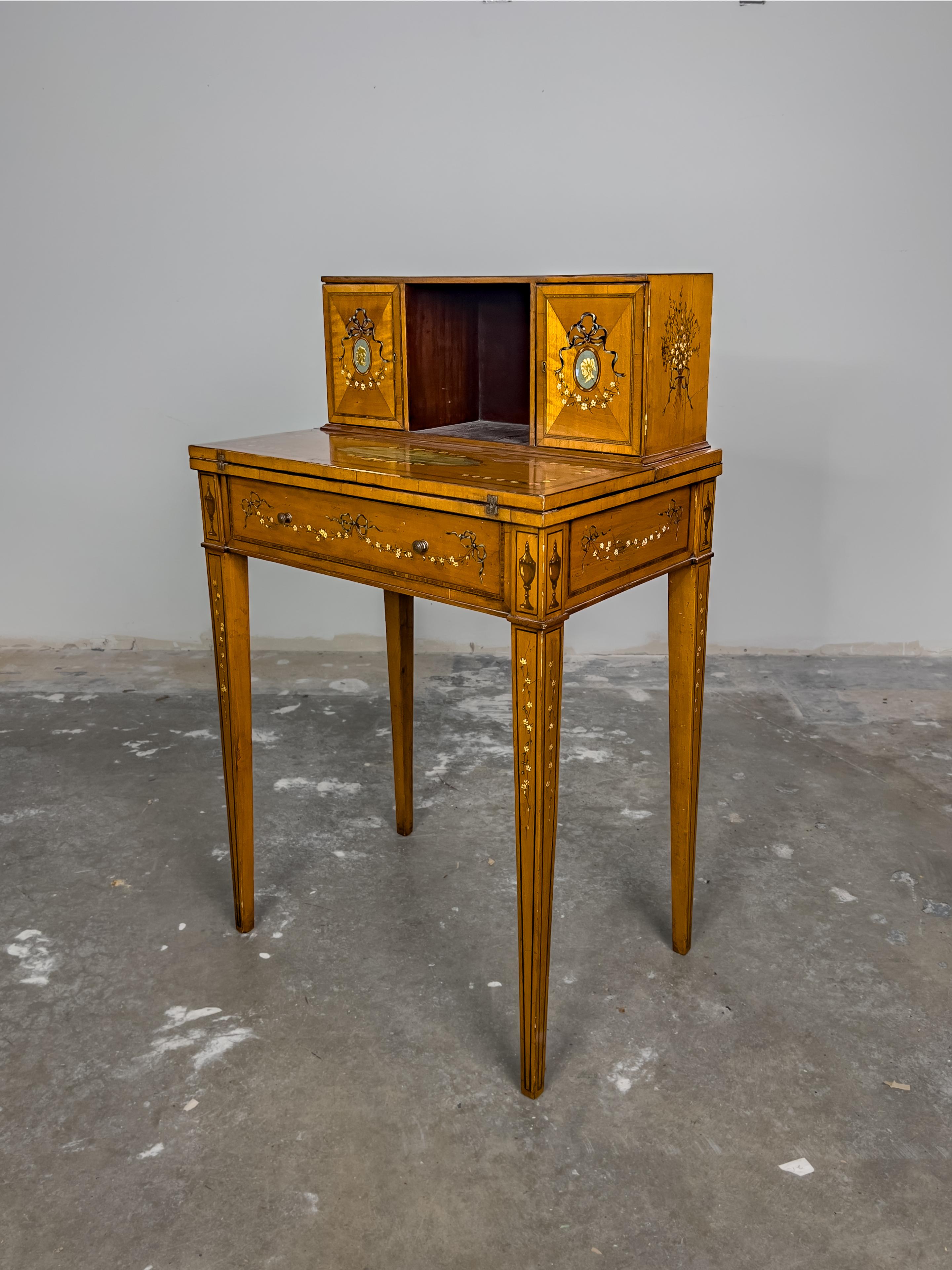 Vintage Inlay and Hand Painted Desk with a fold front desk and superstructure with cabinets doors and concealed drawers. The painted detail is typical of the neoclassical Adams style decoration.