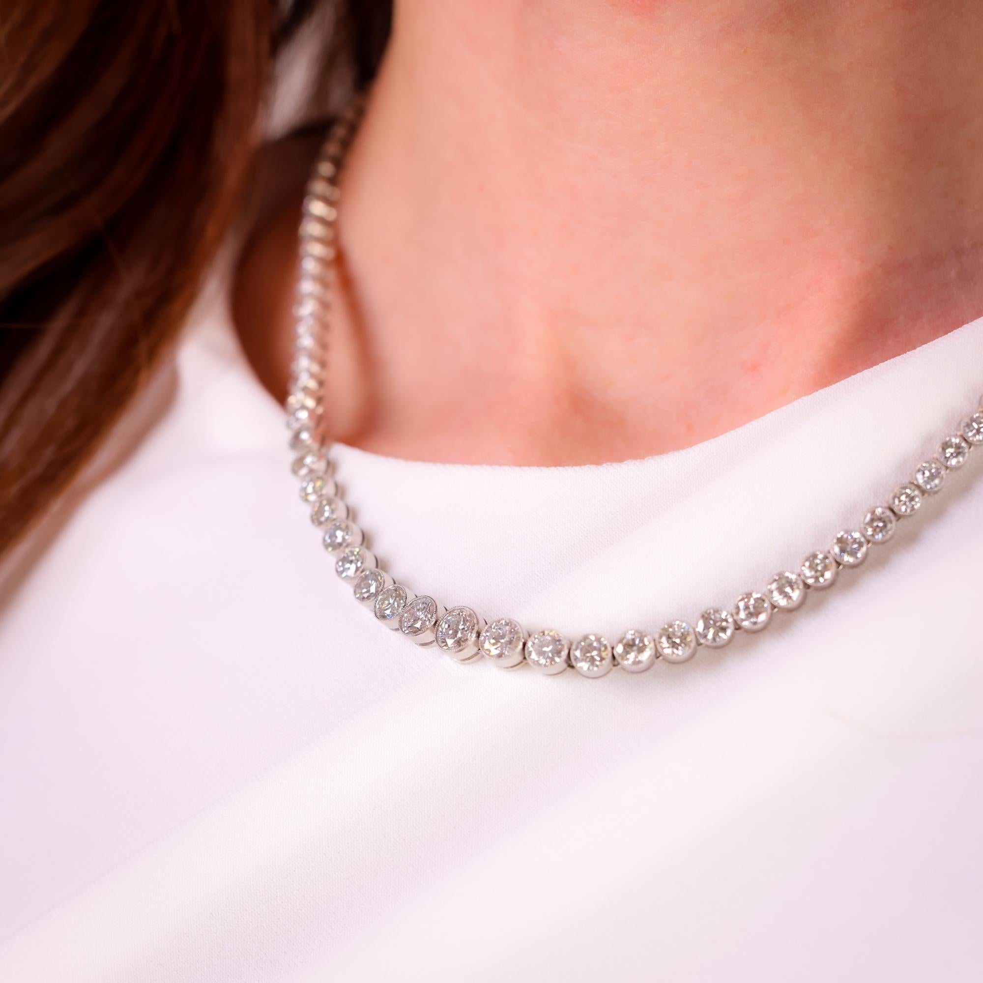 This Art Deco-inspired platinum necklace from the 1980s features 14.58 carats of dazzling round brilliant diamonds, offering timeless elegance and vintage sophistication.

Center stone: 119 round brilliant diamonds
Weight: 14.58 carats
Color: