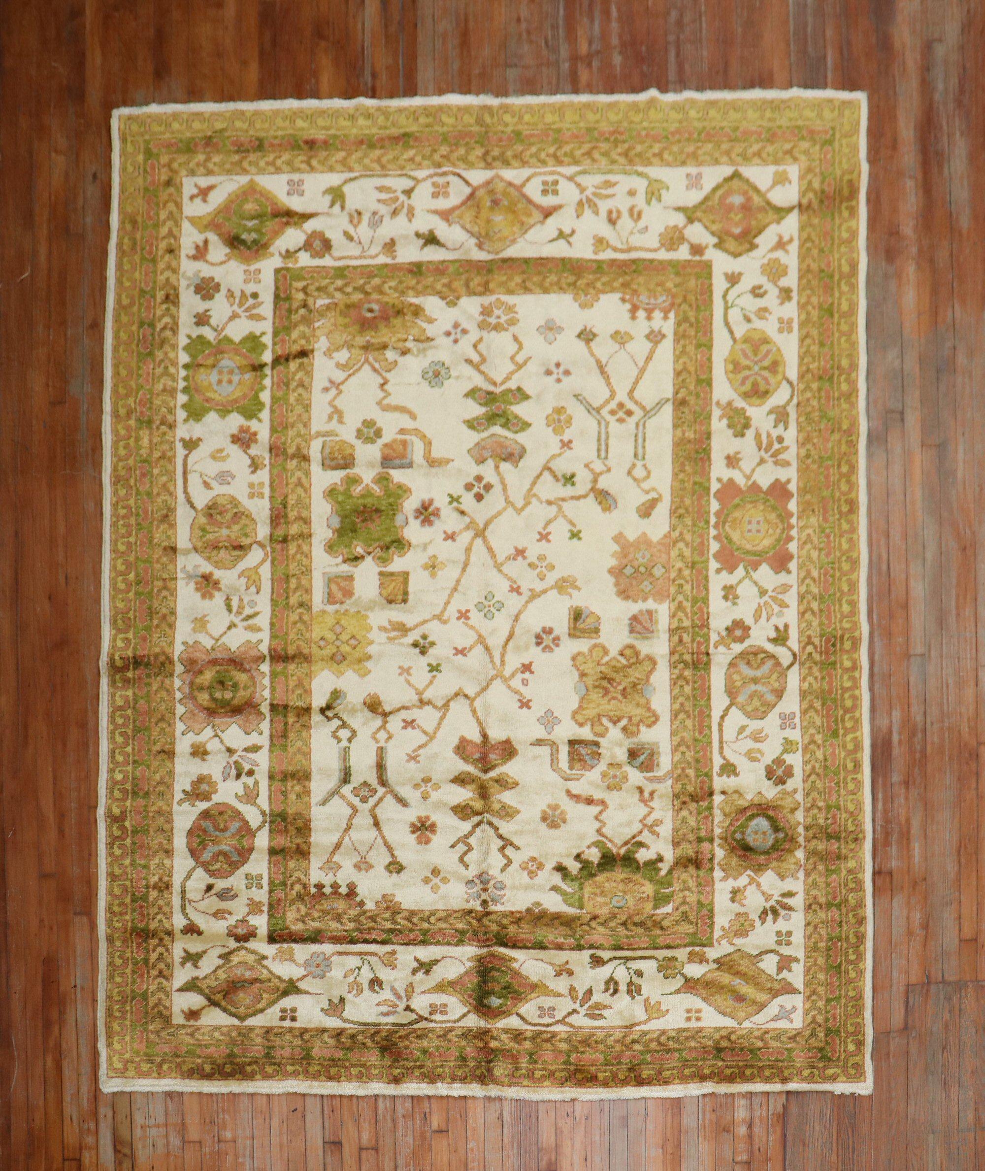 A One of a kind Turkish Oushak rug with olive accent colors on an ivory ground woven with angora wool

Measures: 8'2'' x 10'3''.