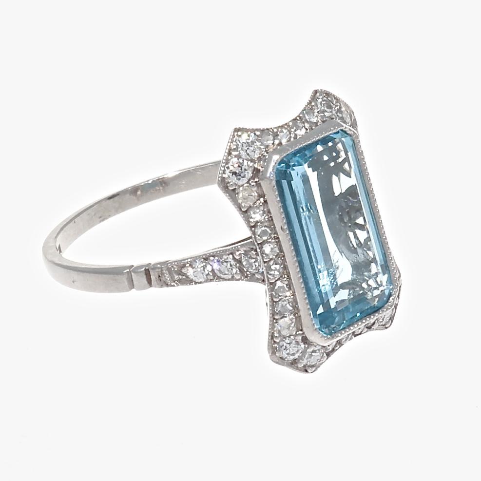 Learning from the past, this modern made ring is a combination of geometric design, style and color. Featuring a 2.10 carat aquamarine surrounded by near colorless diamonds. Hand crafted in platinum. Ring size 7-1/4 and can easily be resized to fit,