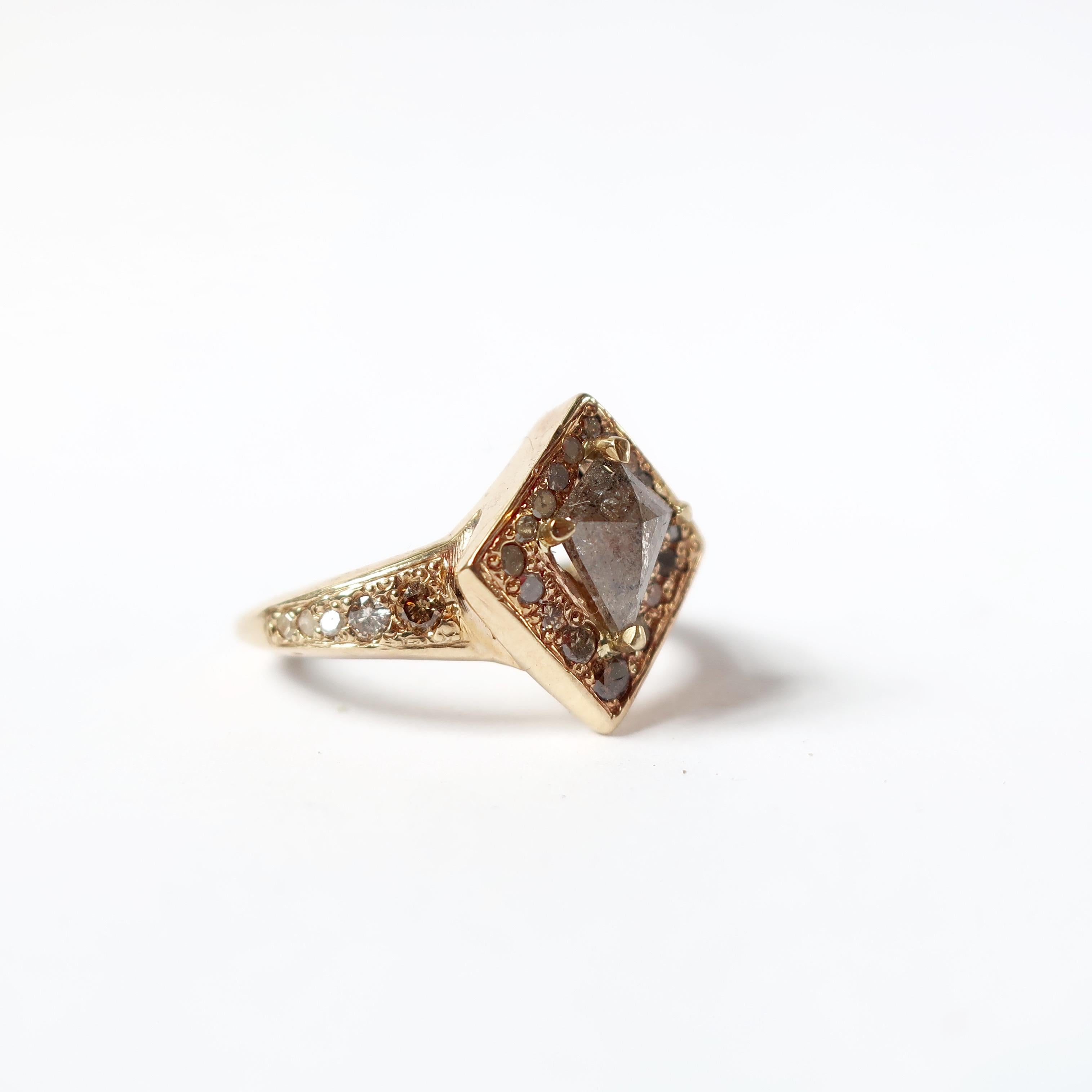 Gorgeous 14k yellow gold engagement ring highlighting a grey kite diamond center surrounded by beautifully selected brown, champagne and white diamonds . Center stone measures 7.6x 6.2mm.

One of a kind Size 4.5

