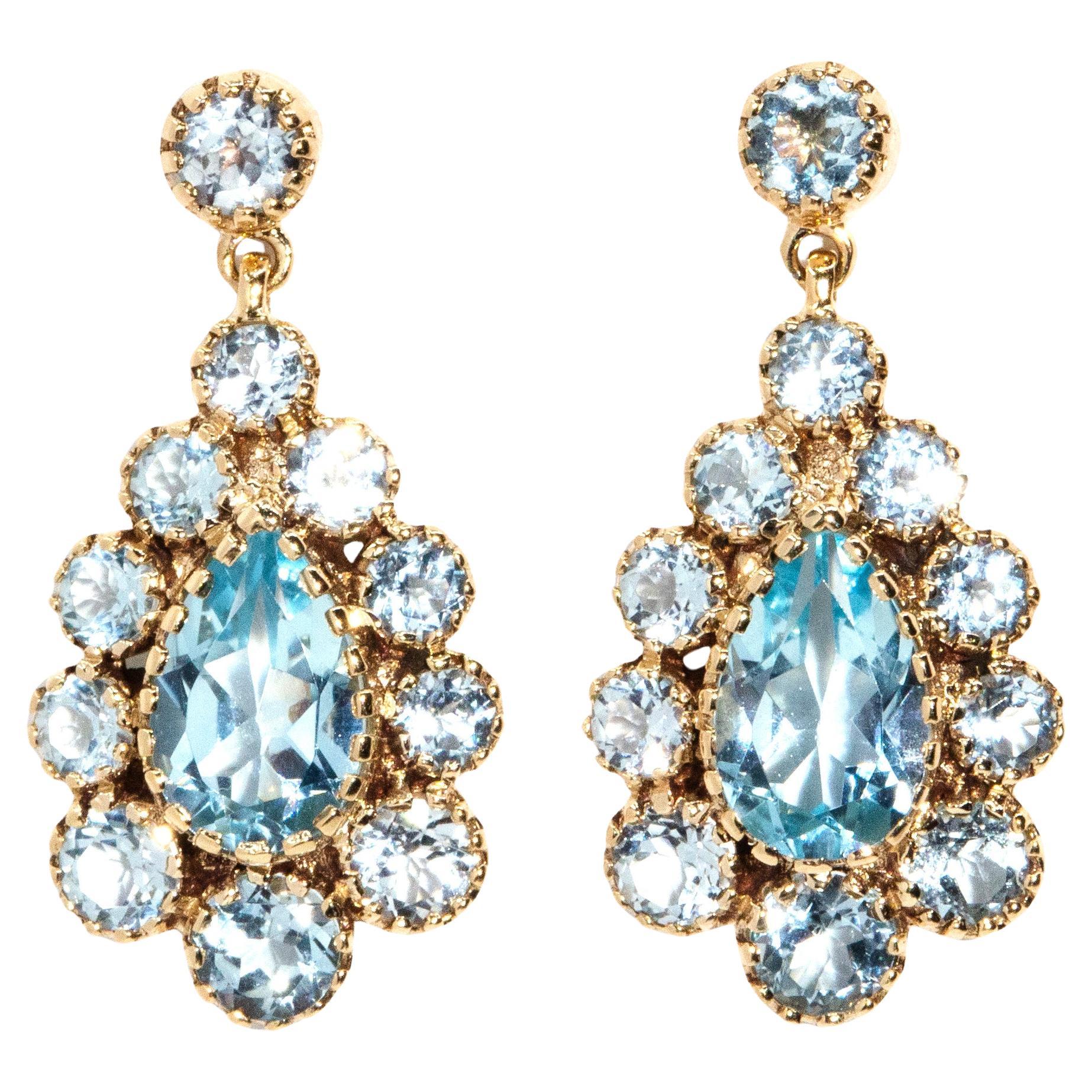 Boucles d'oreilles pendantes d'inspiration Art déco en or rose 9 carats avec topaze bleue