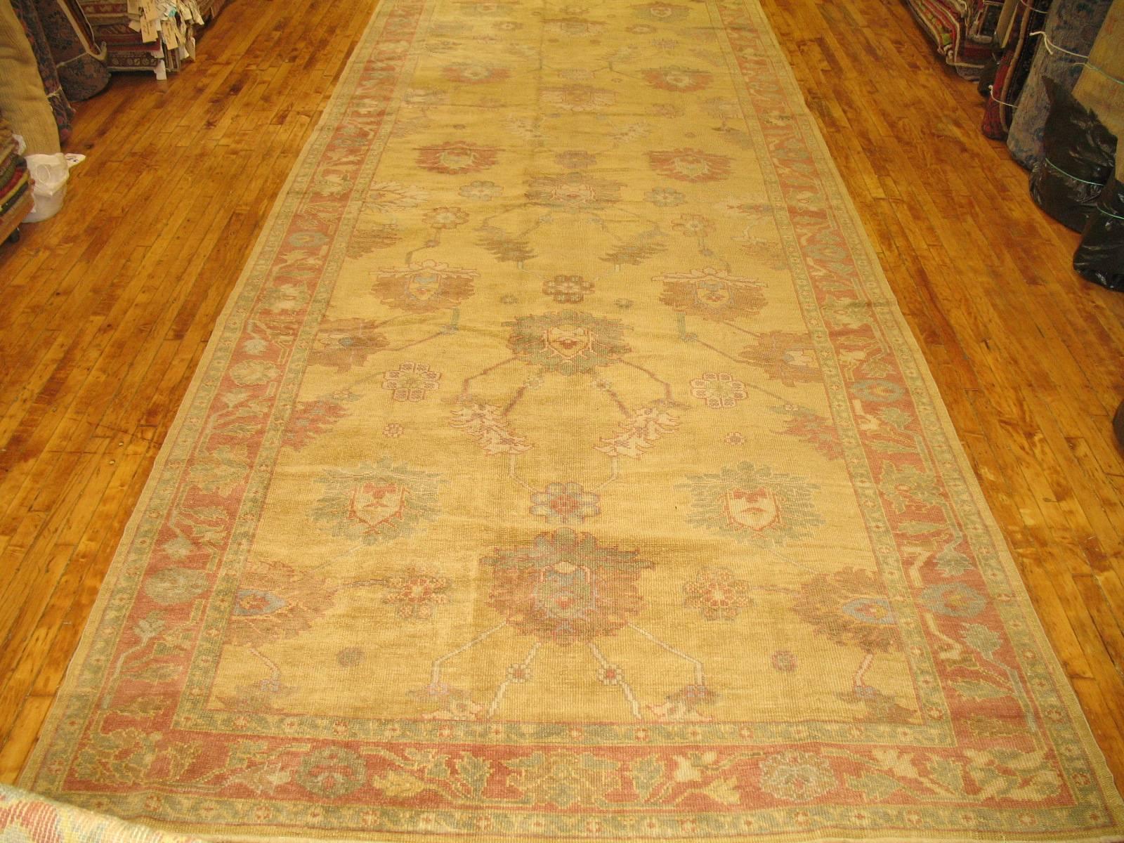 A hand-knotted One of a kind long gallery size Oushak rug designed by co-owner Ilan Zabihi that’s been re-created in our workshop in Turkey using luscious wool derived from early 20th century Oushaks. Colors are executed perfectly on this piece