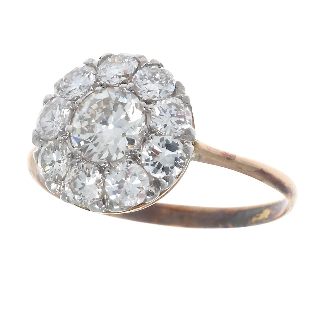 Never out of style, the cluster ring withstands the test of time and has remained popular throughout the decades. Featuring an approximately 0.50 carat old European cut diamond that is elegantly surrounded by 9 diamonds weighing approximately 0.55