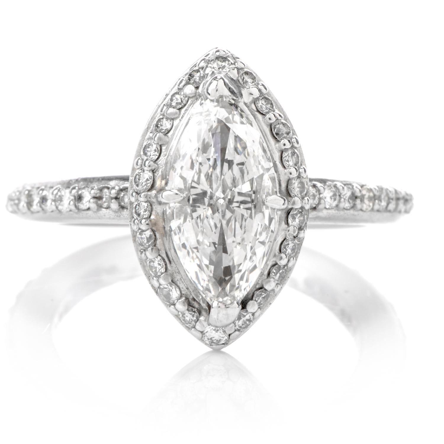 The Timeless Classic designed Diamond Engagement Ring displays a prominent Marquise Halo floating on top of a traditional DIamond band and is crafted in 14K White Gold. Centered atop the ring is a precisely shaped Halo of Diamonds with a Marquise