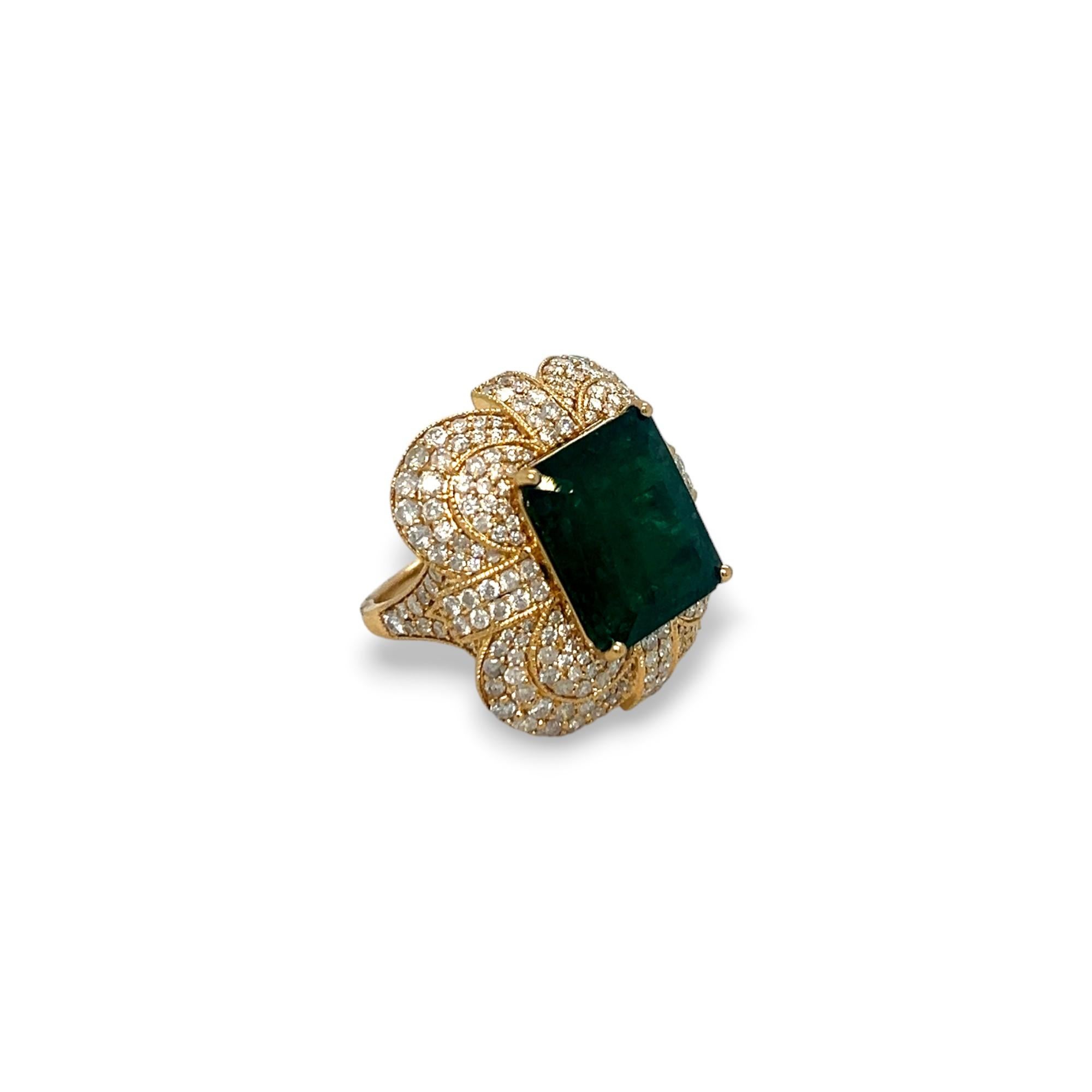 This beautiful vintage-inspired ring features a 8.08 ct emerald center stone embellished with 2.27 total ct of round diamonds set on a 14k yellow gold band. Ring can be sized upon purchase.