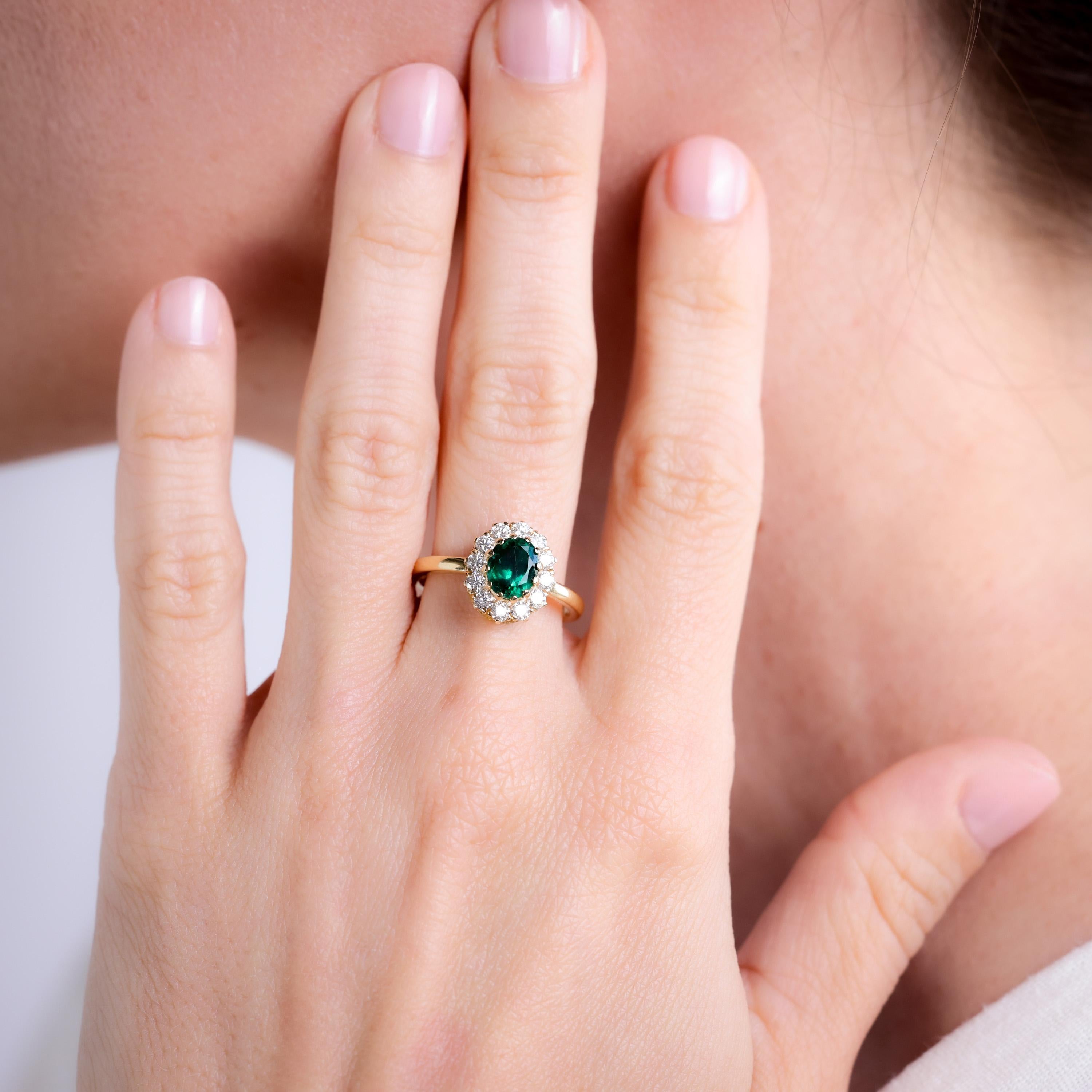 Brand: Trampet&Horn
Center Stone: Emerald
Cut: Oval
Weight: Approximately 1.25 Carats
Color: Green
Accent Stone: 12 Diamonds
Cut: Round Brilliant
Weight: Approximately 0.58 Carats
Color: F-G
Clarity: VS
Metal: 18K Yellow Gold
Era: Vintage