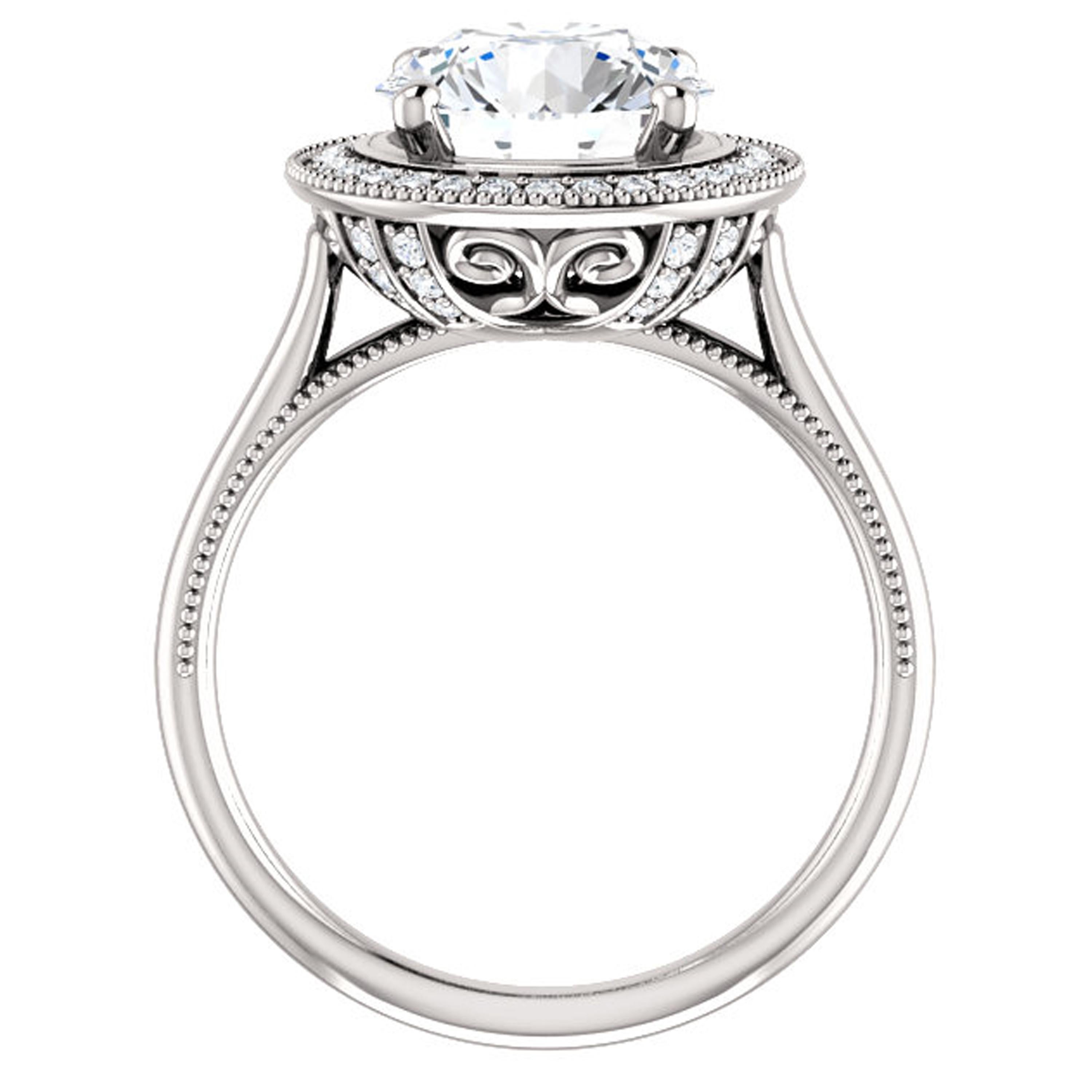 Inspired by the Victorian era, intricate milgrain detailing adorns the shank and halo of this vintage style engagement ring. Shimmering white diamonds surround the halo and glorify the center. Beautiful filigrees and surprise diamonds decorate the