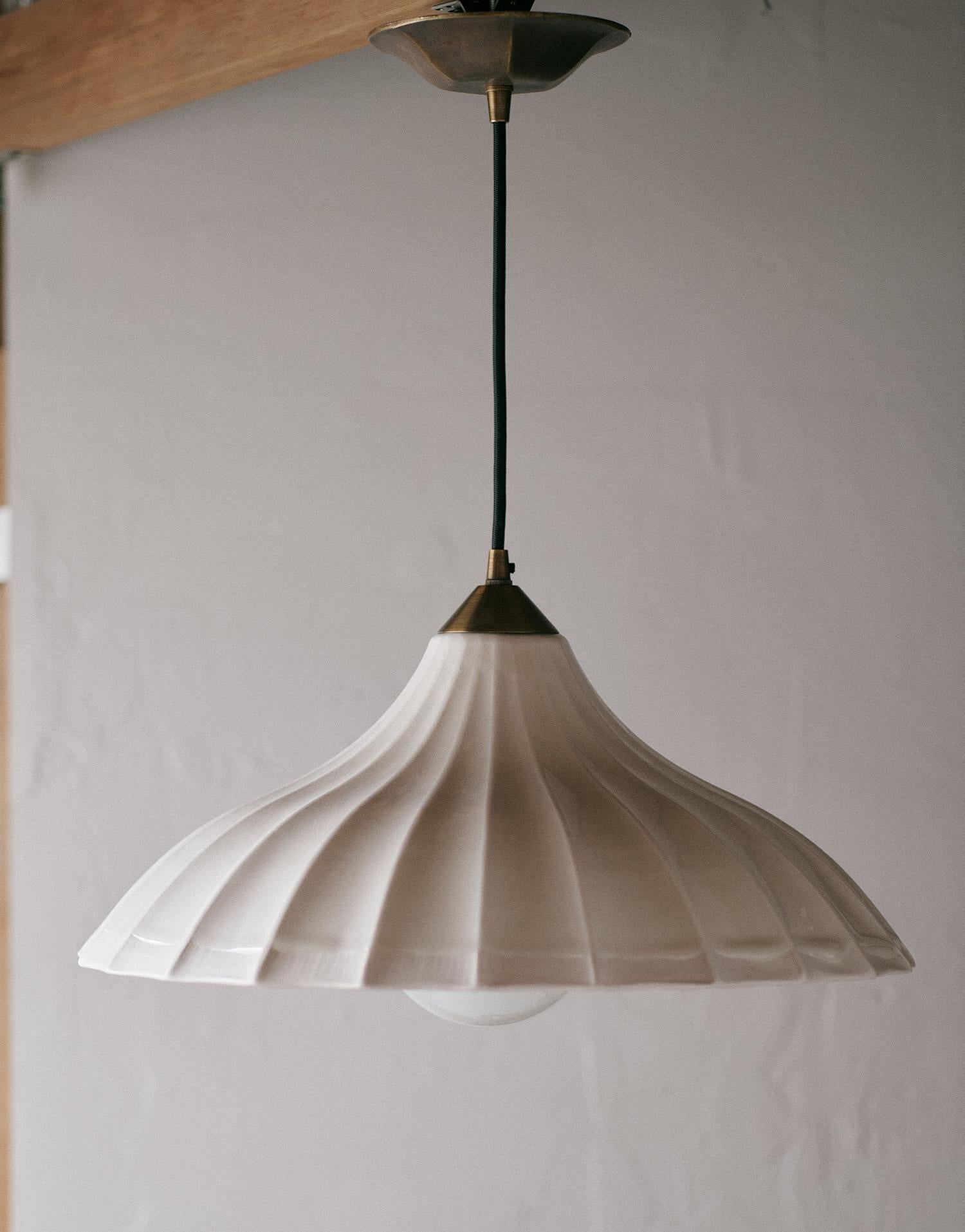 Classic, elegant, with a perfectly imperfect touch. We just love our new porcelain Parasol Fluted Pendants. Inspired by a vintage pie cover, we designed them to hang over our kitchen island to add a unique touch to our most used room in the house.