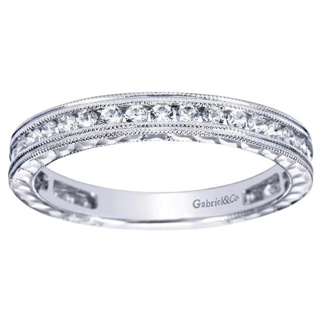 Vintage inspired milgrain channel set diamond band in 14k white gold by Gabriel Co. Band contains 0.45 ctw of fine white round brilliant cut diamonds, H color, SI clarity. Hand etched sides.