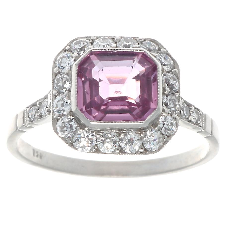 The perfect way to say I love you, with a modern creation inspired by the romantic Art Deco era. Featuring a 1.38 carat electric pink sapphire surrounded by a halo of near colorless diamonds. Crafted in platinum. Ring size 6-1/2 and can easily be