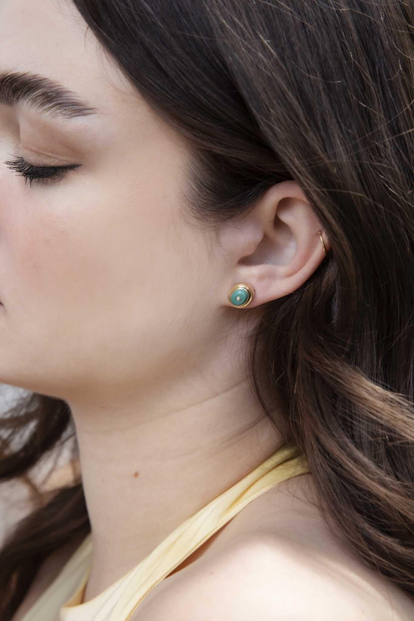 The Gina Earrings are a subtle blend of creamy turquoise and seed pearls framed in ribbons of gold. Worn when the curtain falls and the madding crowd of the theatre has scattered into the night, she is for you and yours.

The Gina Earrings Gem