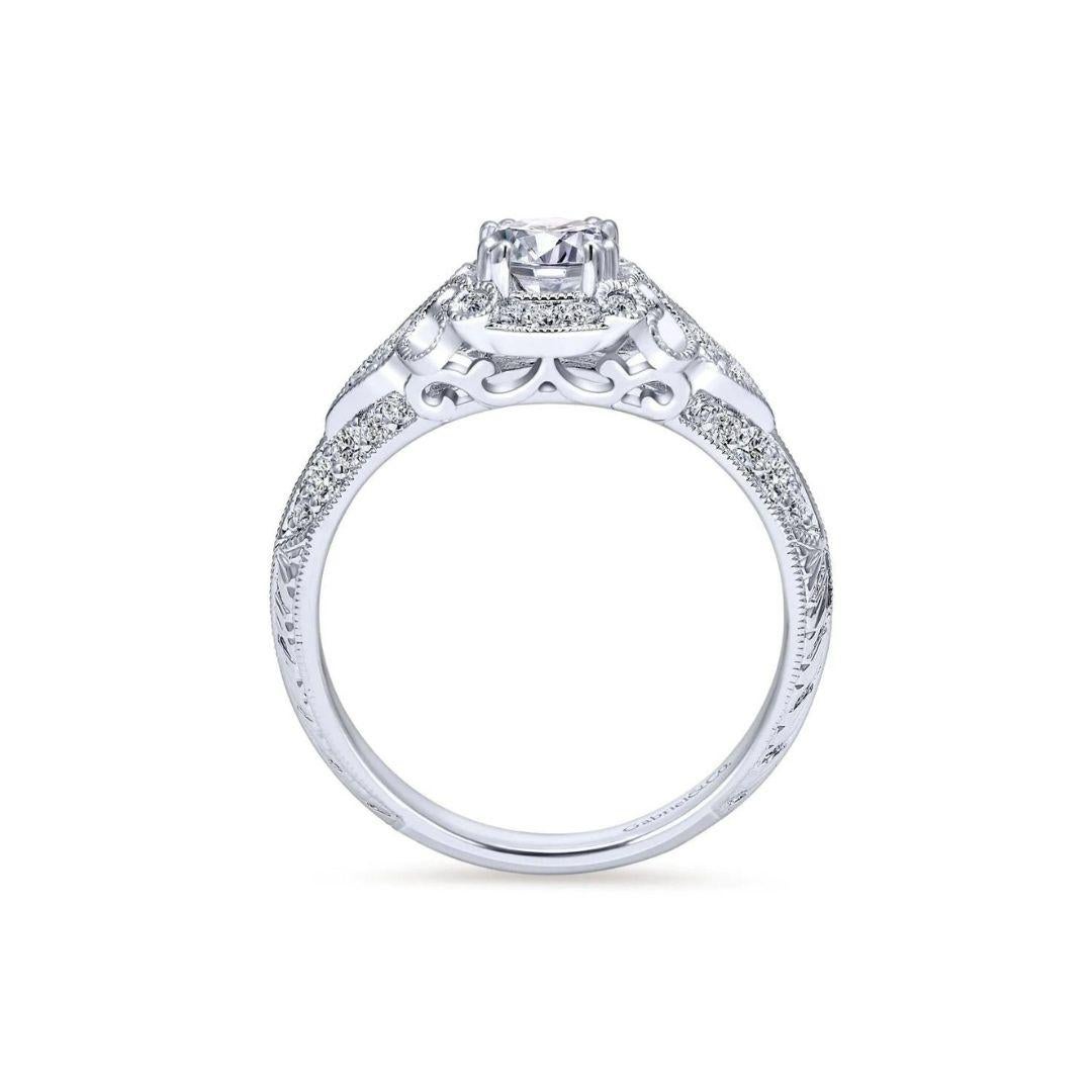Ladies' 14k White Gold Diamond Engagement Ring﻿. Elegant vintage halo with milgrain finish, beautiful pave diamonds on the sides, and filigree scrolling give this one of a kind ring a romantic vintage appeal. Center certified diamond included, 0.65