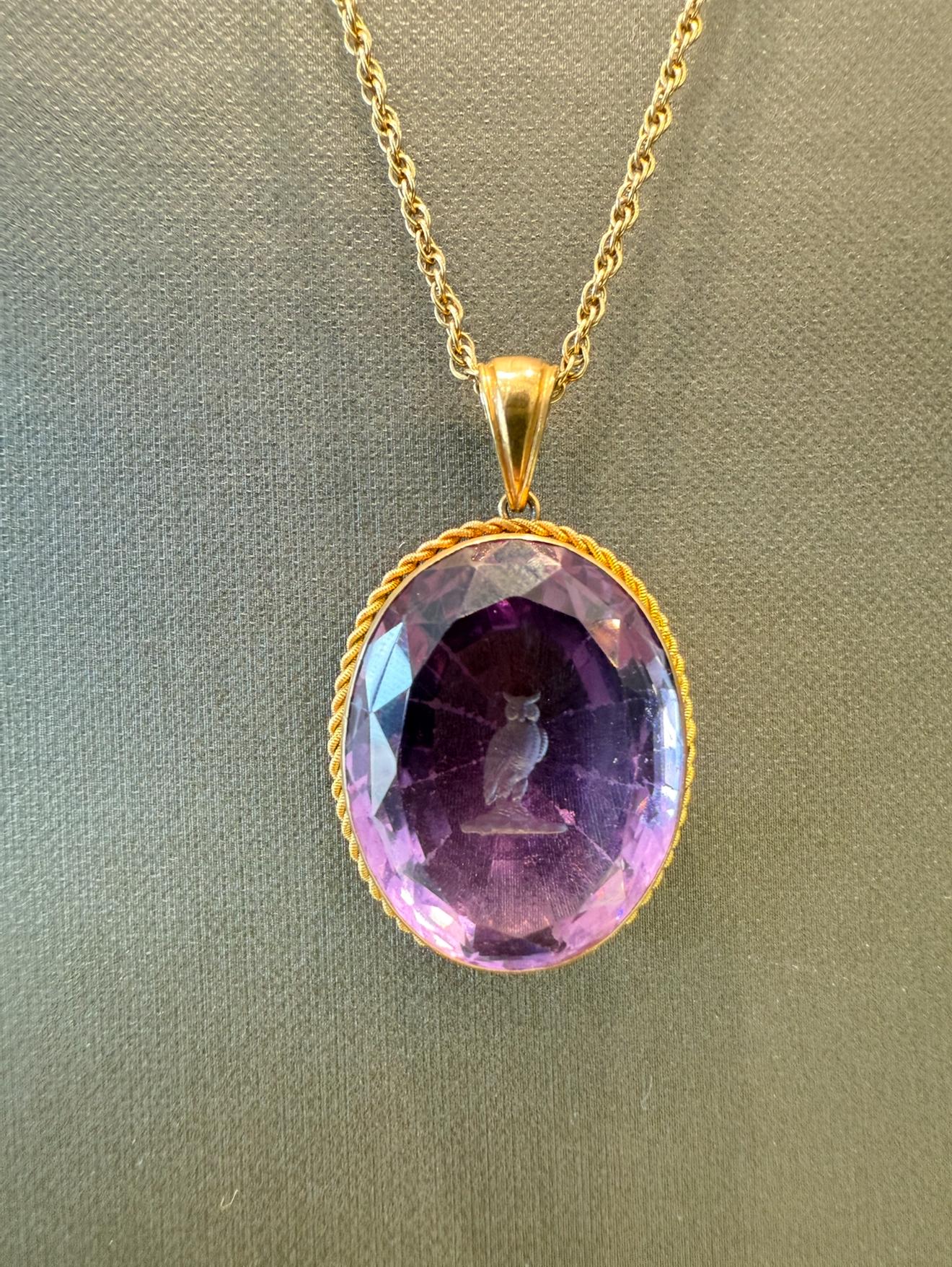 Vintage Intaglio Owl Amethyst Pendant Necklace in 14K Yellow Gold. The pendant features an approximately 20ct Amethyst on a 27 inch long chain. The pendant measure approximately 1.5