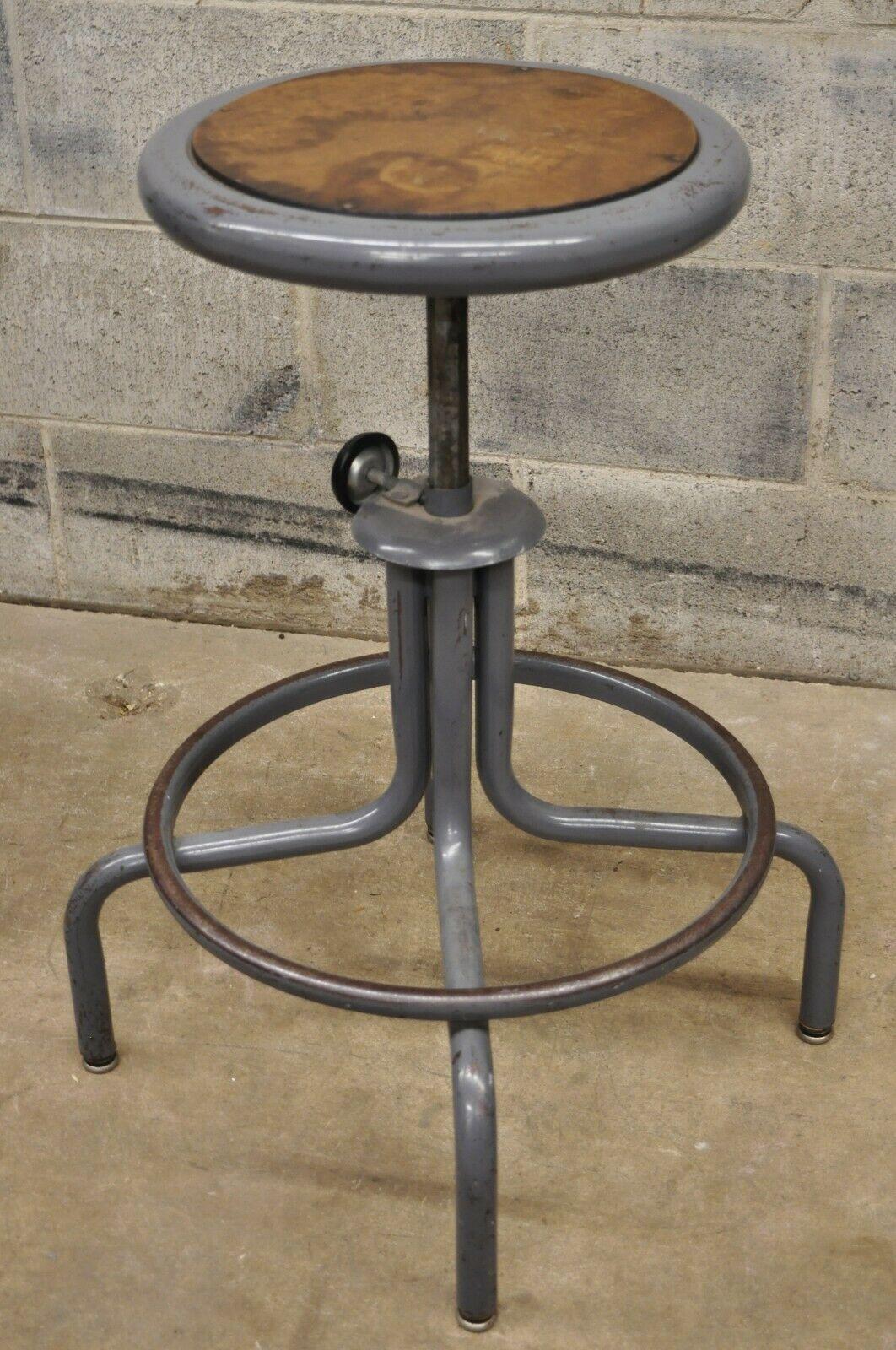 Vintage inter royal corp grey metal adjustable swivel work stool seat. Item features adjustable height, swivel seat, original label, quality American craftsmanship. Circa mid to late 20th century. Measurements: 22-27