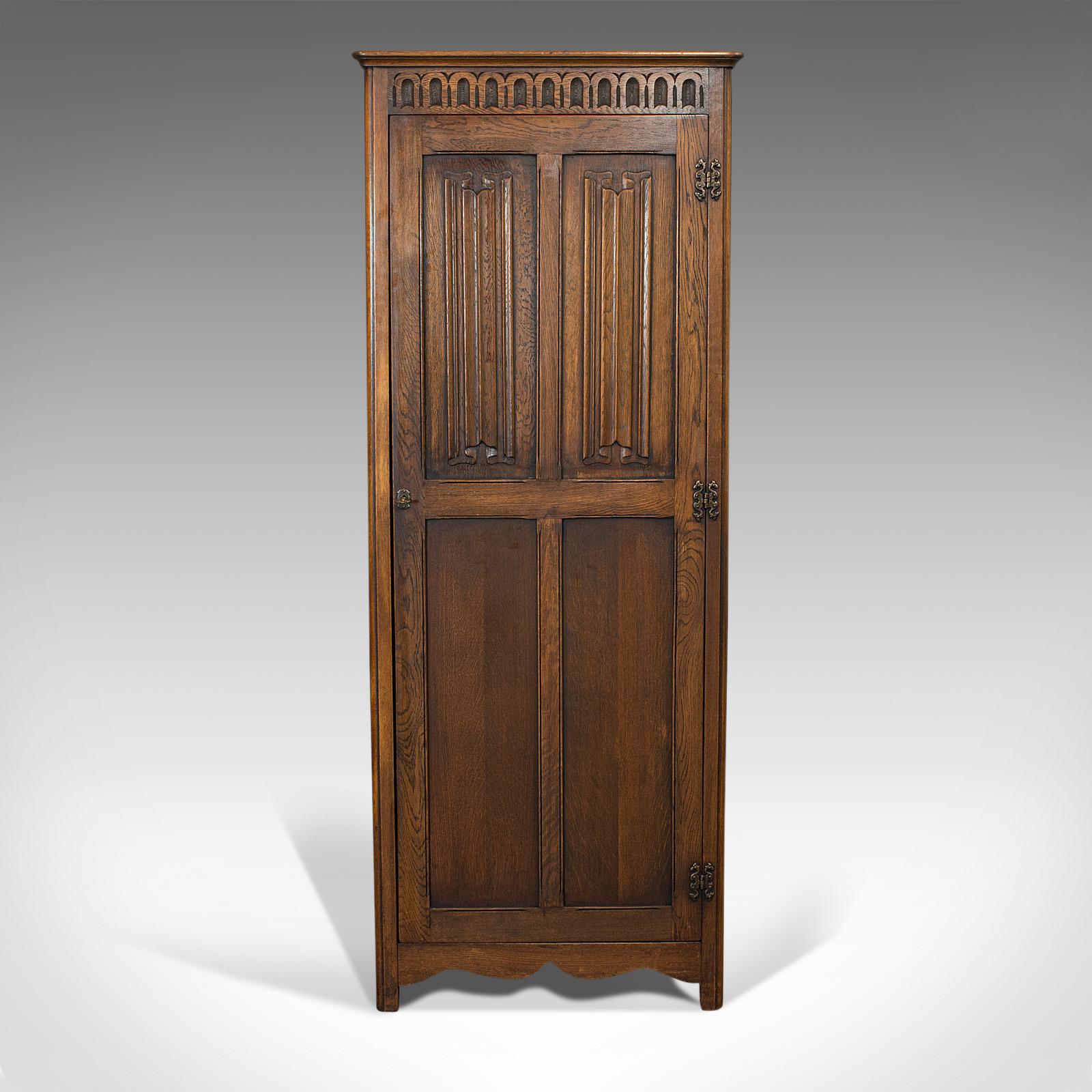 This is a vintage Ipswich wardrobe. An English, oak four panel cupboard from the Art Deco period, circa 1930.

Wonderfully carved example
Displays a desirable aged patina
Select oak shows fine grain interest
Deep caramel hues to the wax polish