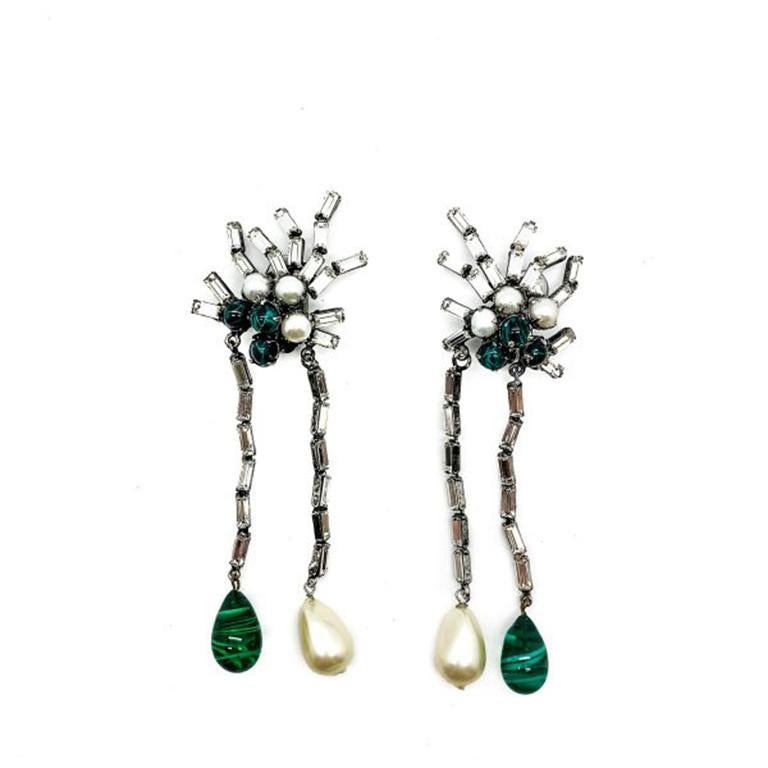 A jaw dropping pair of shoulder duster style Vintage Iradj Moini Earrings.  Statement and to die for design. Featuring stunning emerald green art glass beads and drops with pearls and crystals.  Iradj Moini has designed since the end of the 1980s in