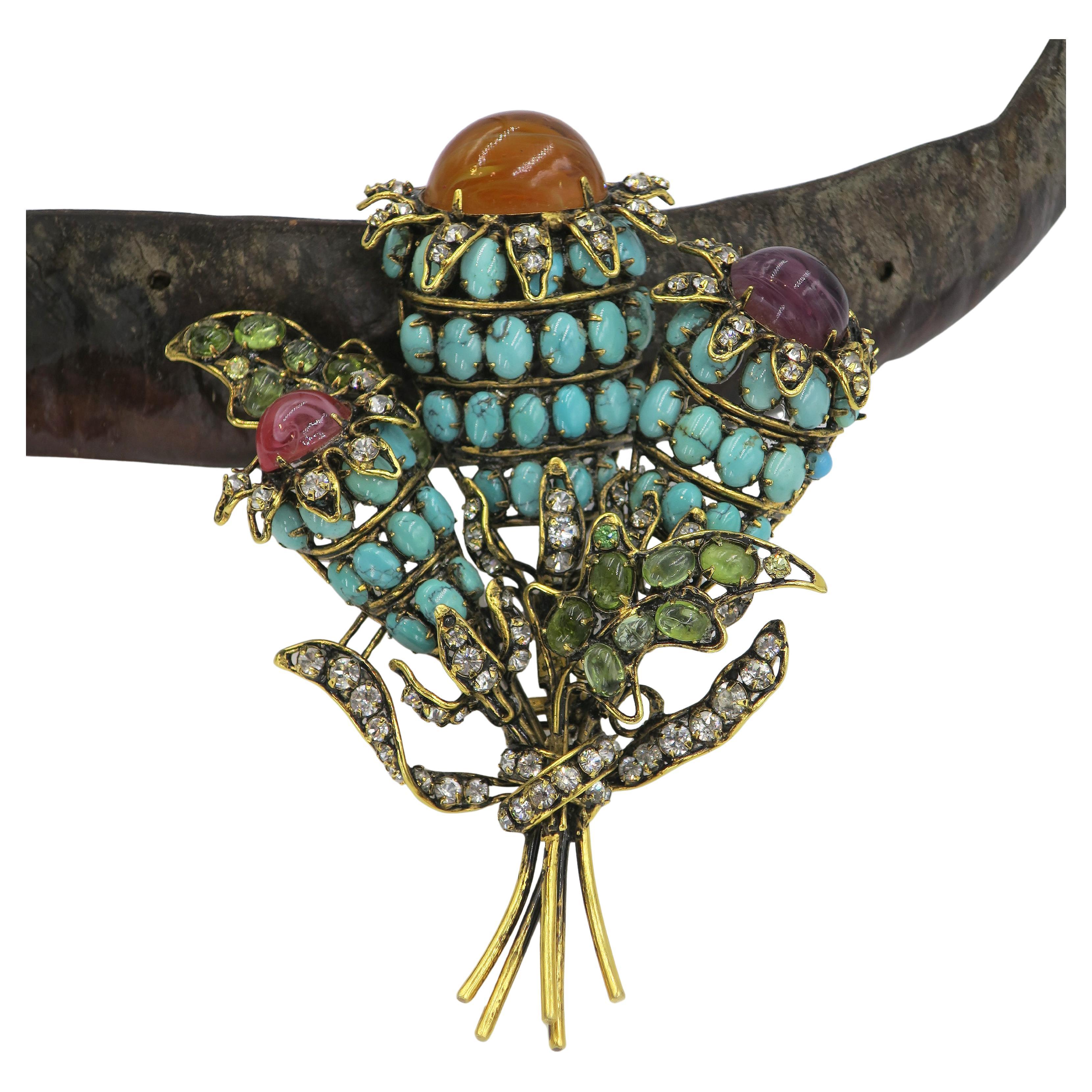 Large Iradj Moini floral bouquet fur clip 3 flowers with oval turquoise & peridot, clear rhinestones & color glass cabochon, Oversize brooch is crafted in brass tone metal. Two pin closure, each with safety lock.

Approximate Gross Weight:
92.20
