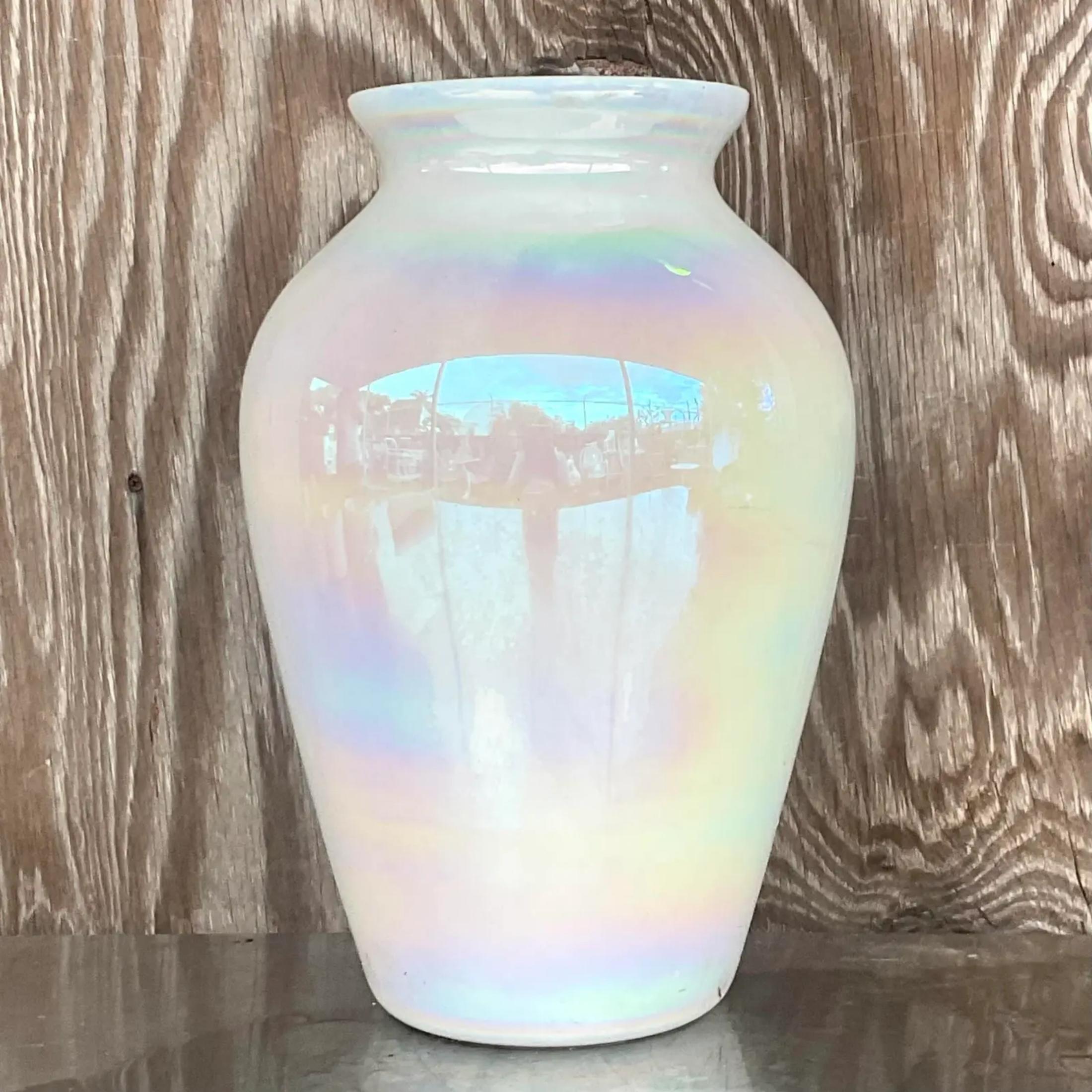 A beautiful vintage Boho white glass vase. A chic iridescent glaze gives it an almost bubble like coloration. A great way to add a little flash of glamour to any space. Acquired from a Palm Beach estate.