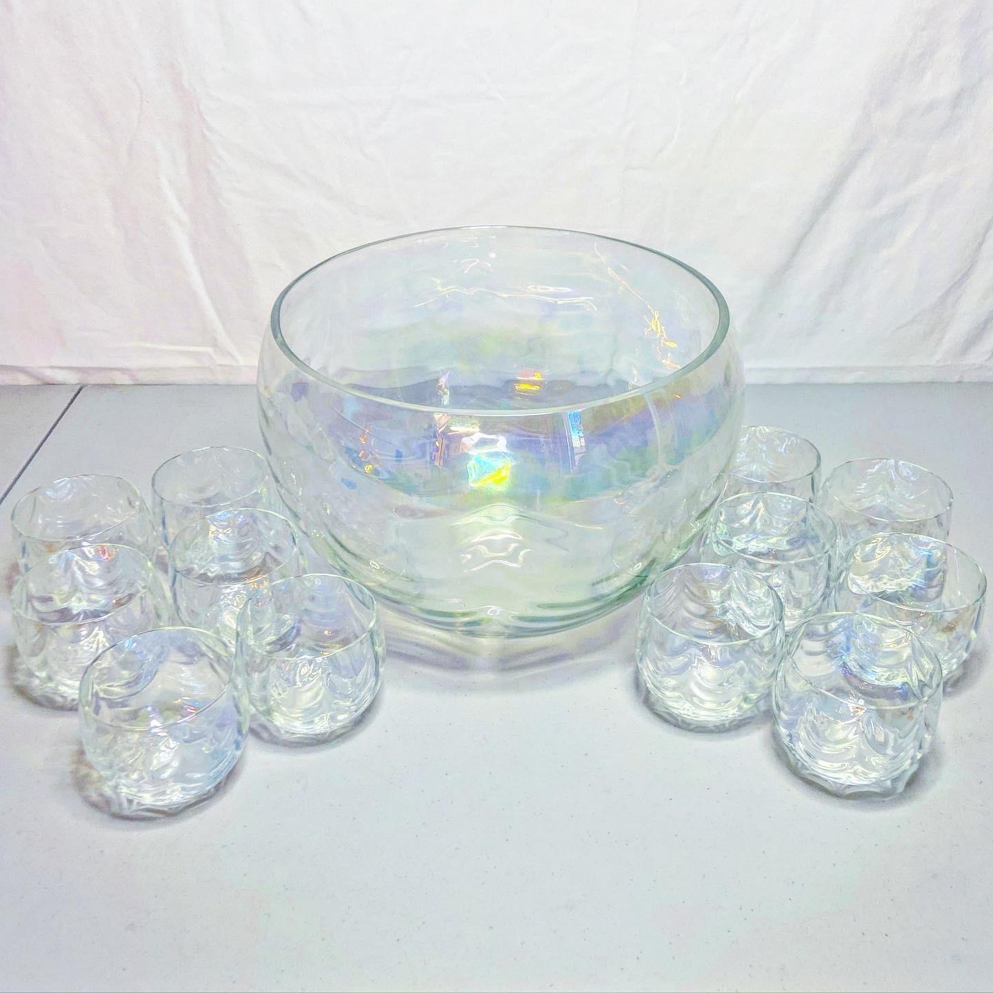 Exceptional punch bowl set with 12 glasses. Features an iridescent glass.

Each cup measures 3”D, 2.75”H.