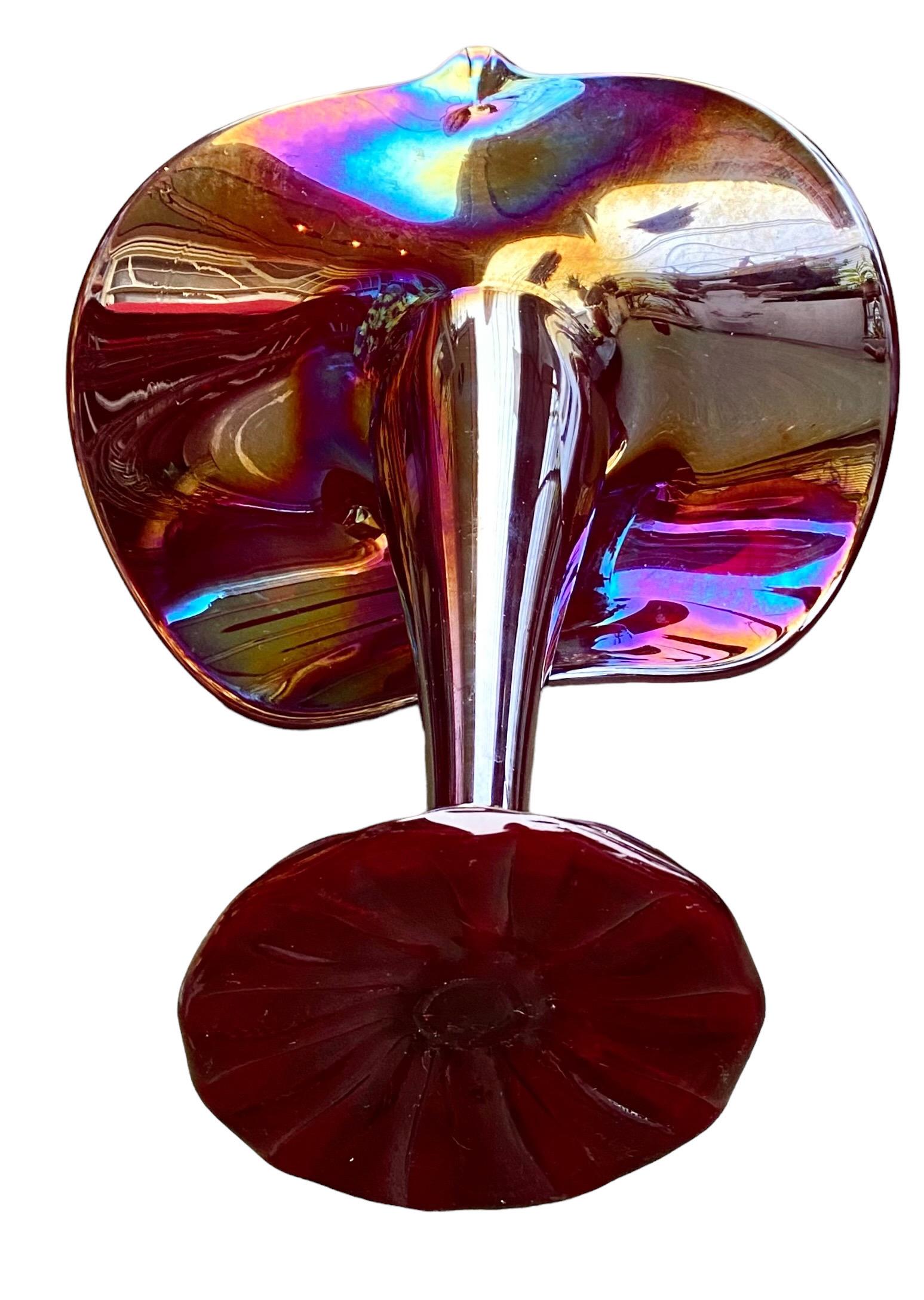 This is an unsigned iridescent studio art glass Jack in the Pulpit or JIP vase. The base glass is a rich deep purple/burgundy. Most art glass of this type made after the mid-1970s was signed. As this is not, we believe it would have been made