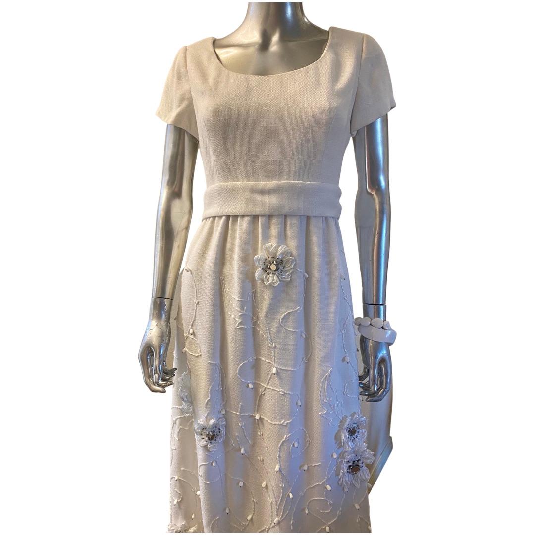 A chic vintage summer Irish linen embellished with the most elaborate floral and embroidery. White raffia, beads, mirrors and embroidery make a magical dress. Custom made (one of a kind) by Truly Social for Dynasty Hong Kong in the 1960s. Removable