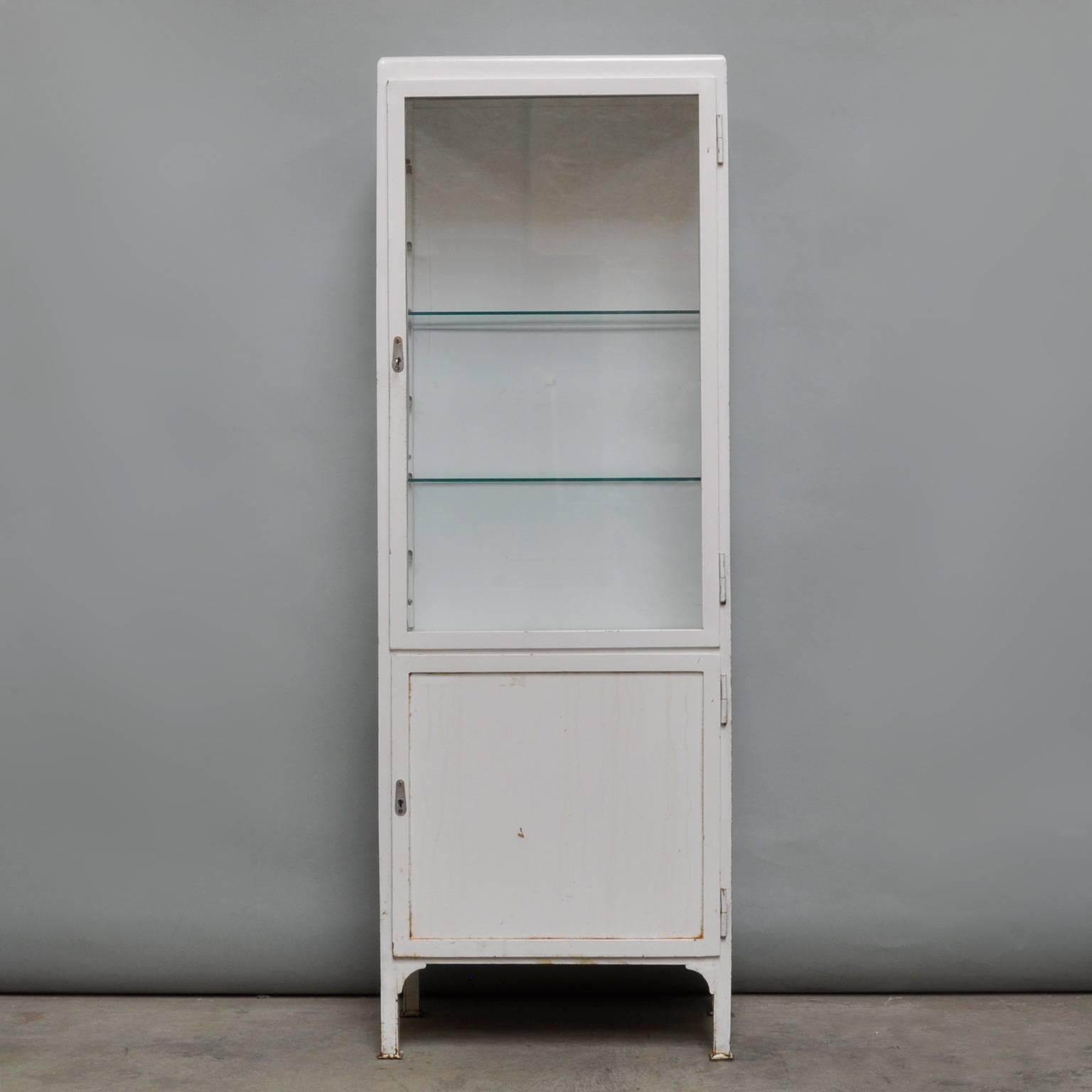 Produced in the Czech Republic in the 1960s. With two (adjustable) glass shelves. Behind the bottom door a steel shelf.