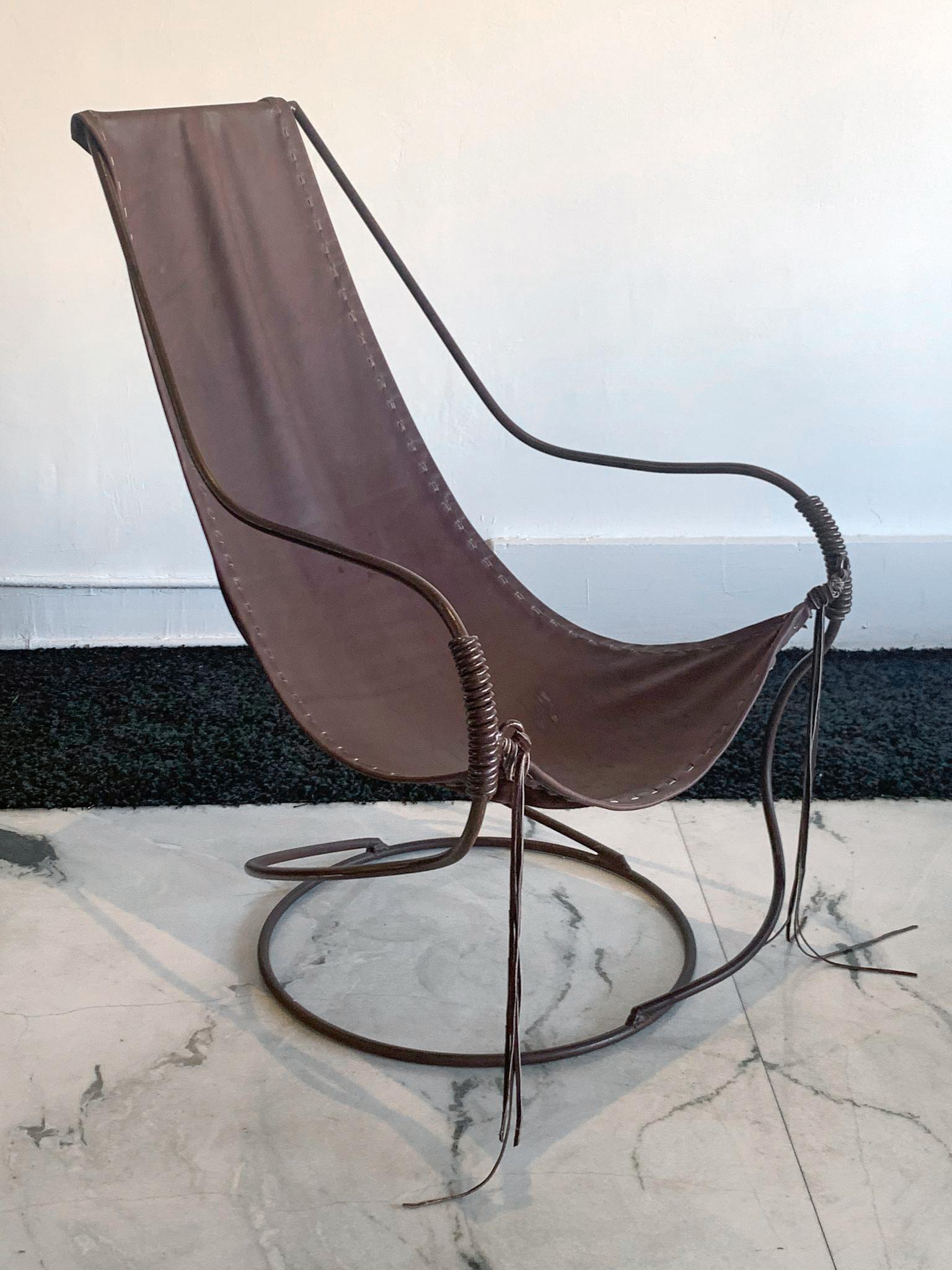 This leather sling chair is absolutely gorgeous. Composed of a wrought iron sculpted frame and supple tanned leather, with leather fringe, this chair is a functional work of art. Evocative of William Katavolos, this sling chair will add a touch of