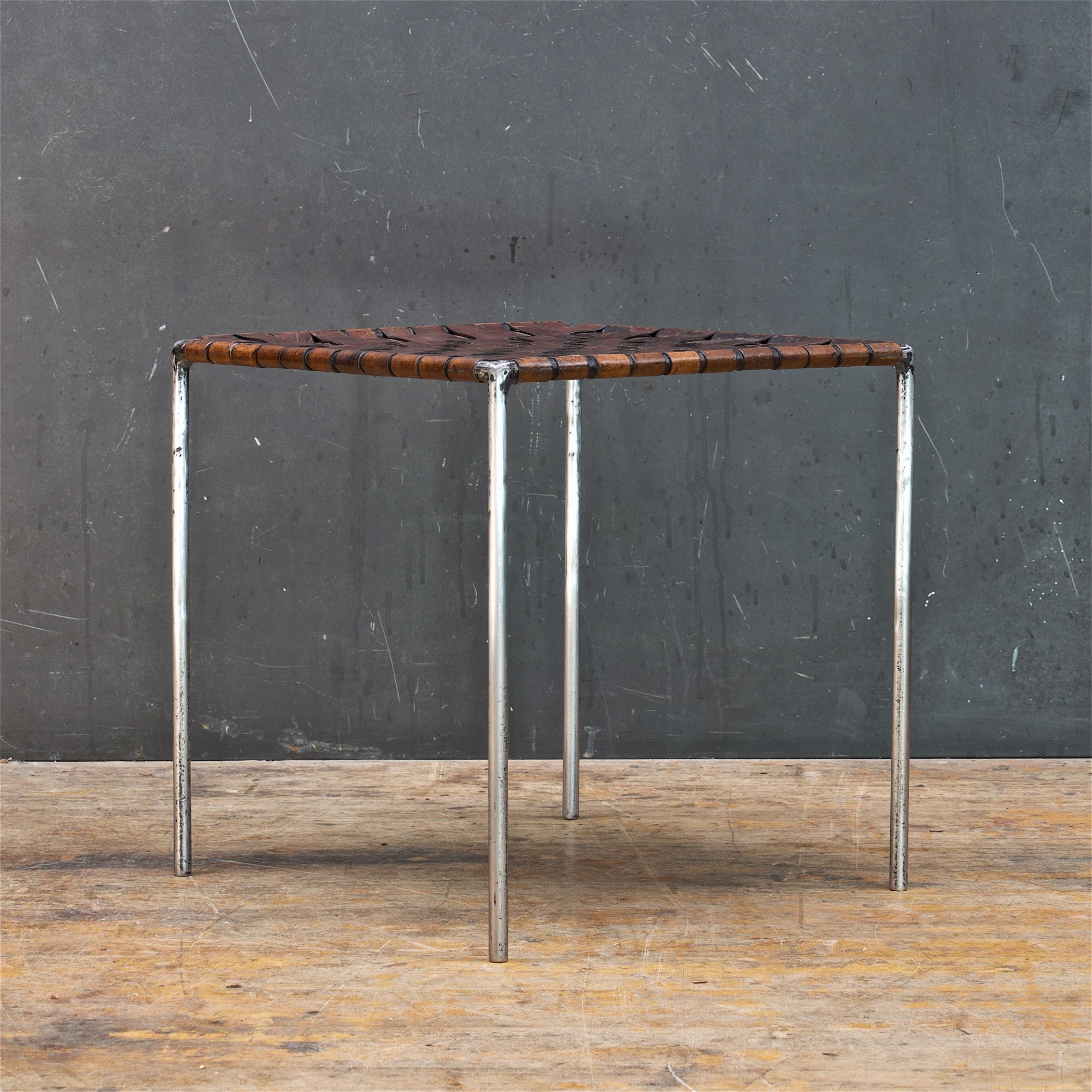 Beautifully patinated mid-century stool with a semi-polished welded iron rod frame, and woven leather seat. This piece is similar to that of Swift and Monell designs, and William Katavalos for Laverne International.