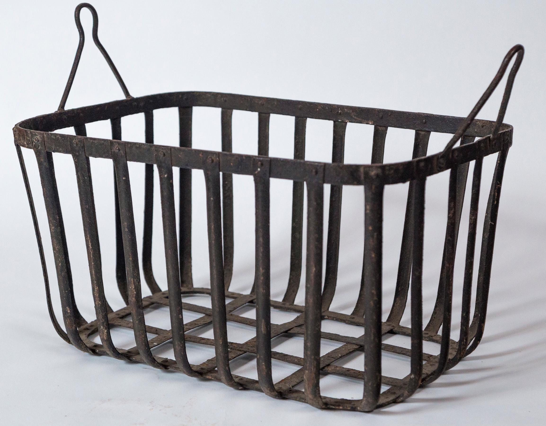 Vintage iron field basket, 20th century. A heavy iron basket that was utilized for harvesting. The handles attached to mechanized equipment. Riveted construction with aged surface.