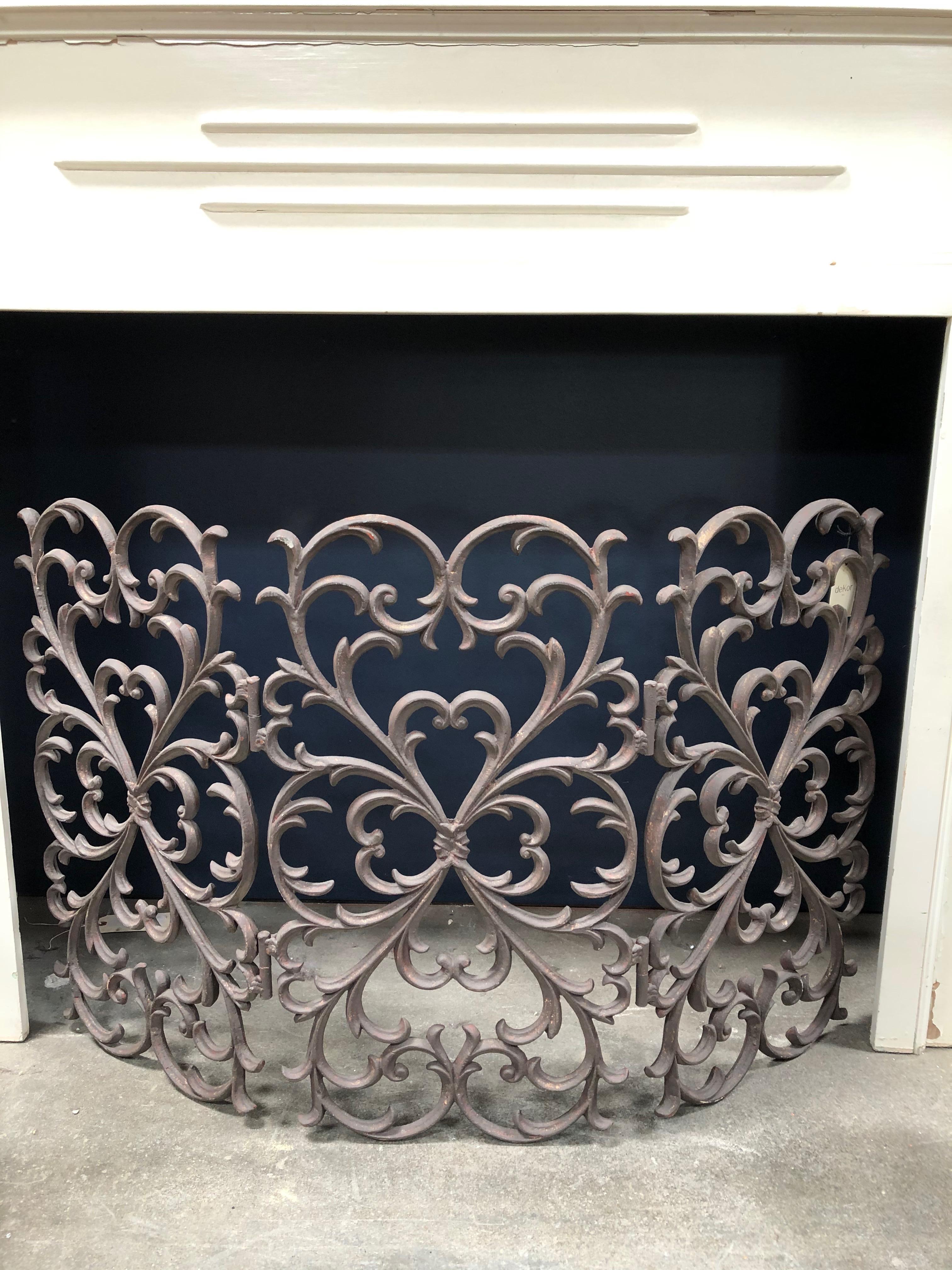 This is a beautifully engraved iron fireplace screen that can be placed at a fireplace for an added decorative statement.