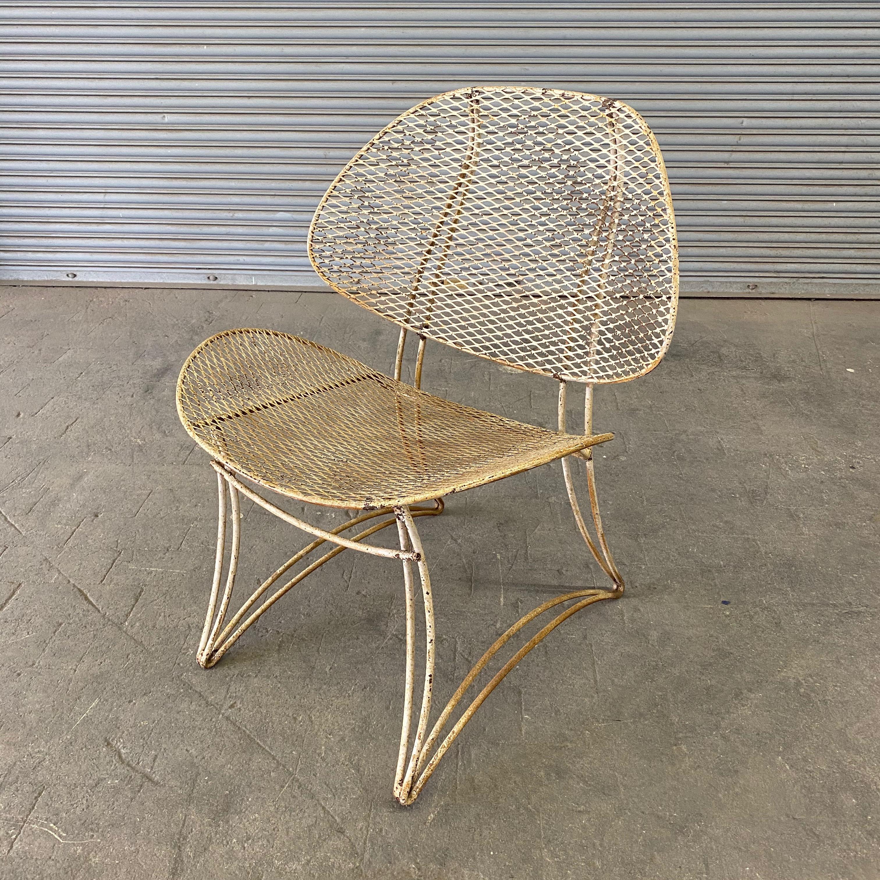 1960s modern garden chair made of iron with original oxidized white paint. Distressed paint finish.
      