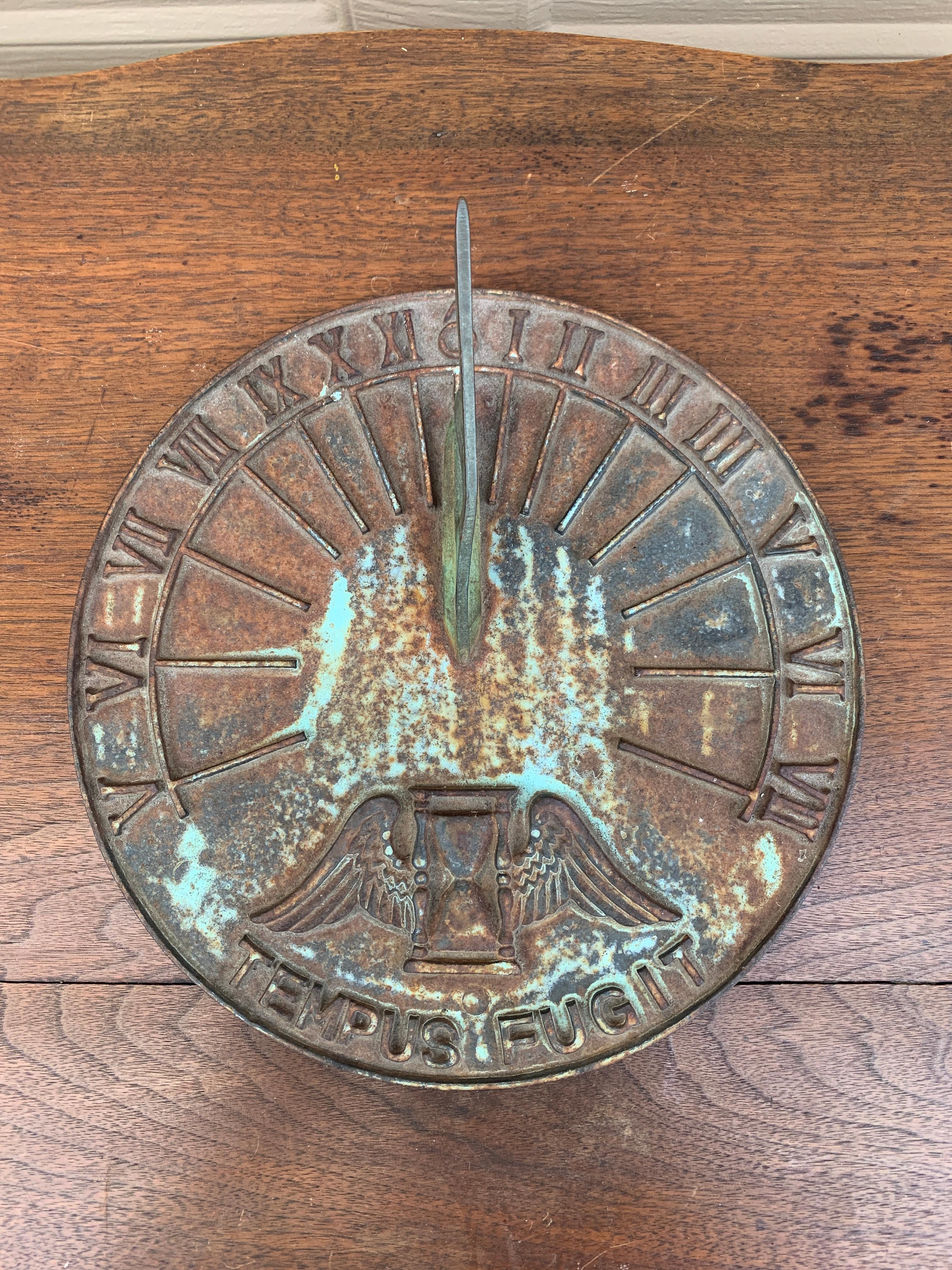 A stunning vintage iron garden sundial reading 