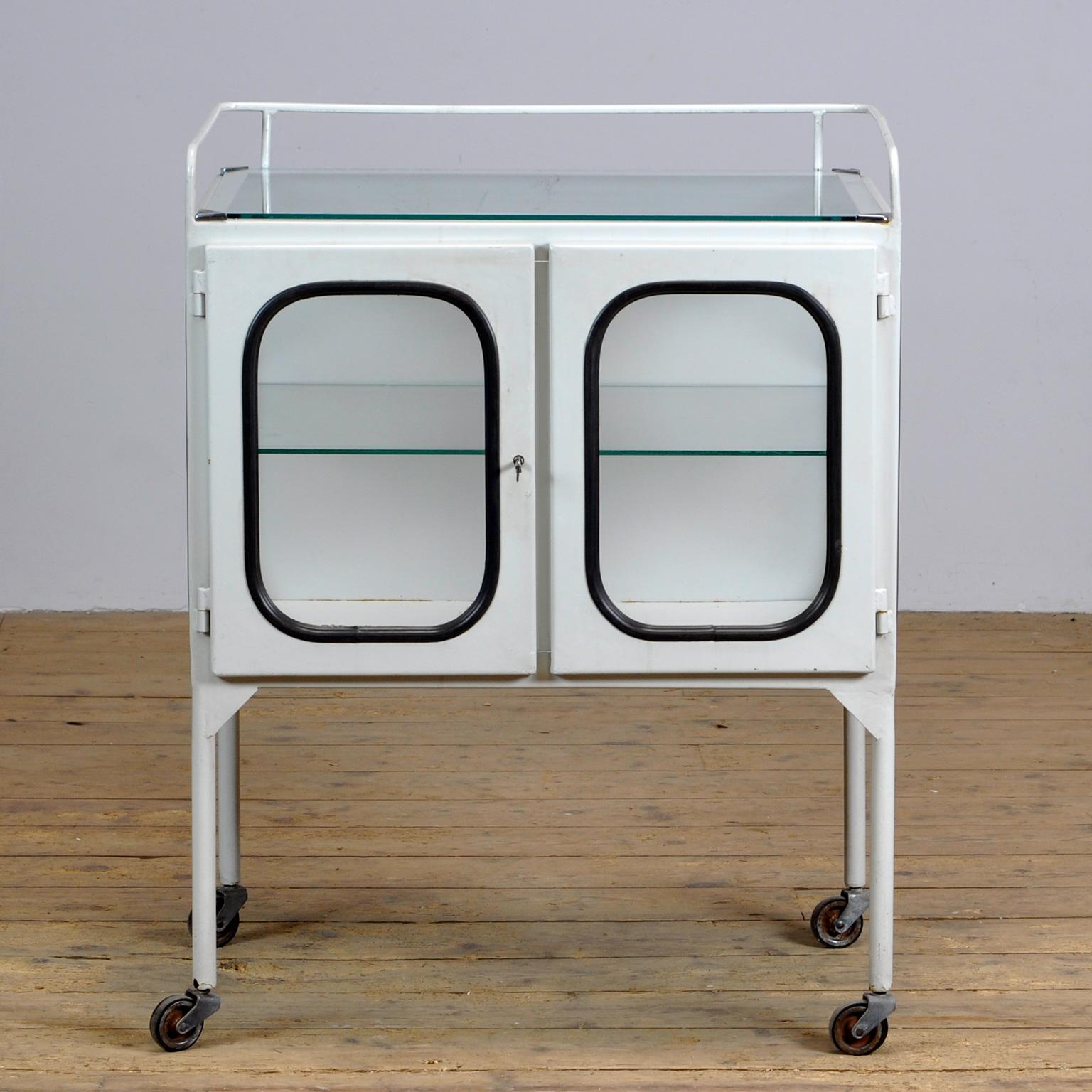 Vintage medical trolley in good condition. Made of steel and glass that is clamped in the steel by a rubber strip. The cabinet is from the 70s and is produced in hungary.