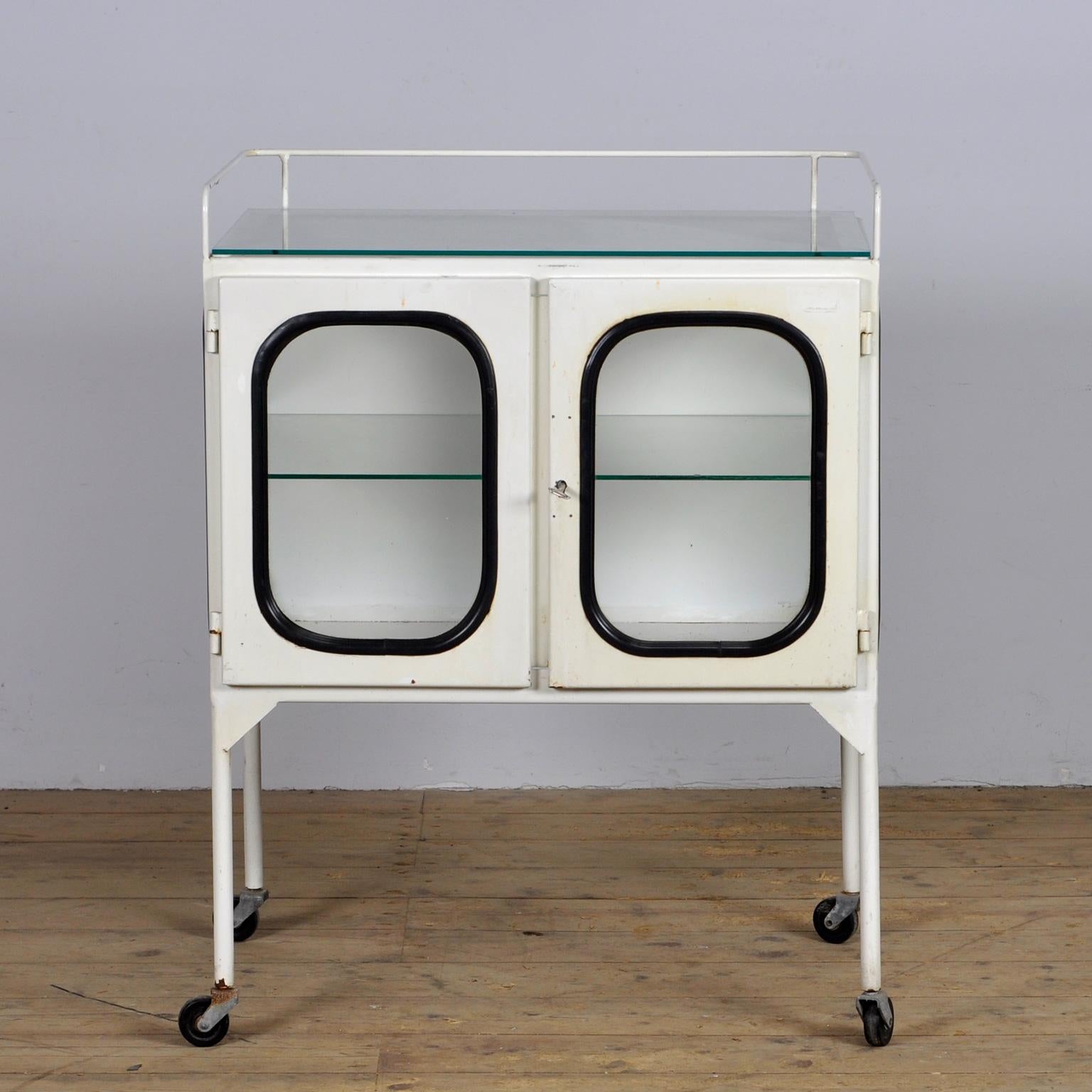 Vintage medical trolley in good condition. Made of steel and glass that is clamped in the steel by a rubber strip. The cabinet is from the 70s and is produced in hungary. 
