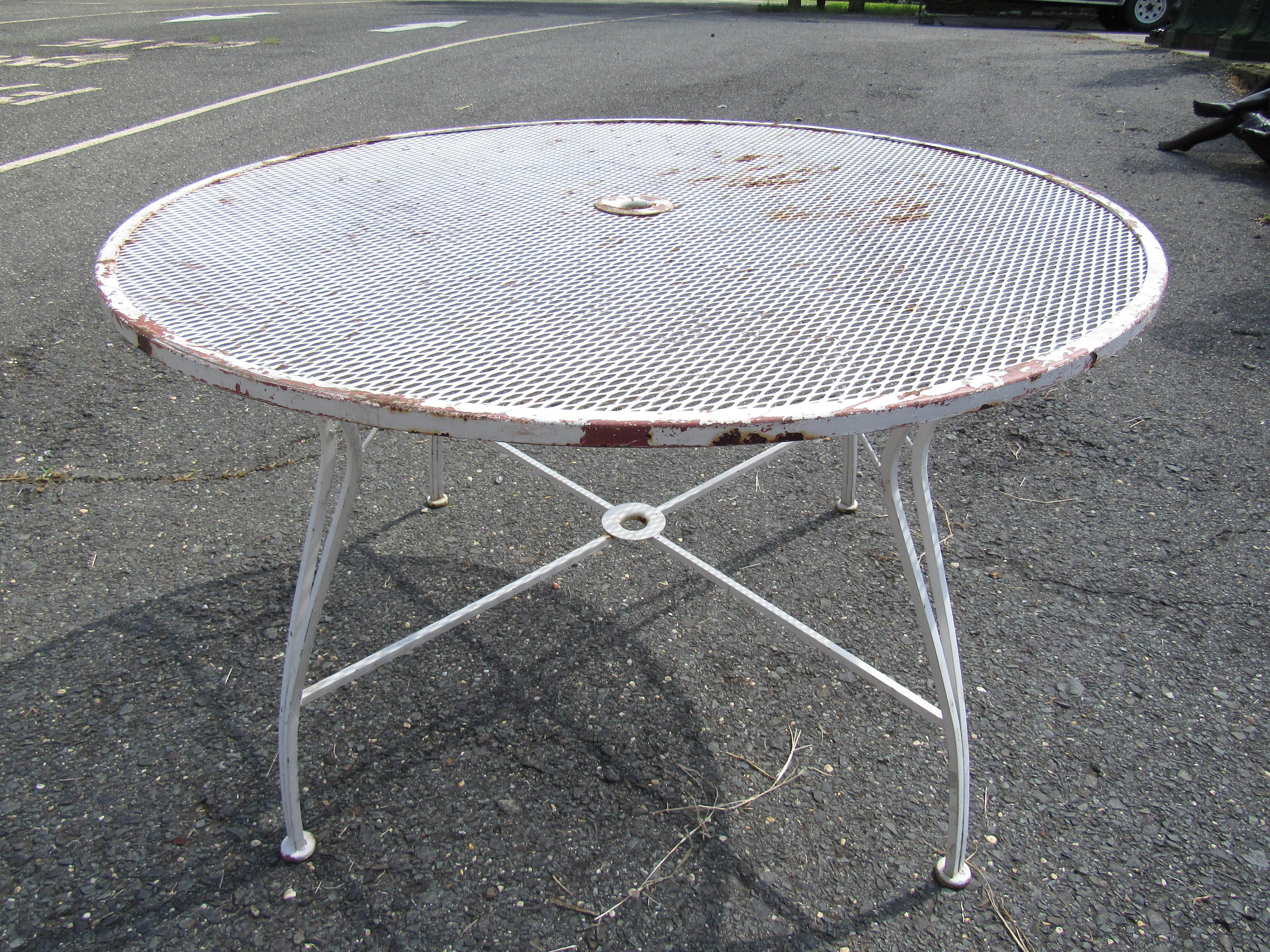 Great patio set including a table and four chairs. Sturdy iron construction that will stand the test of time. Comfortable chairs with stylishly accented armrests. Table has a slot for an umbrella. Great set for any outdoor/patio area. Please confirm