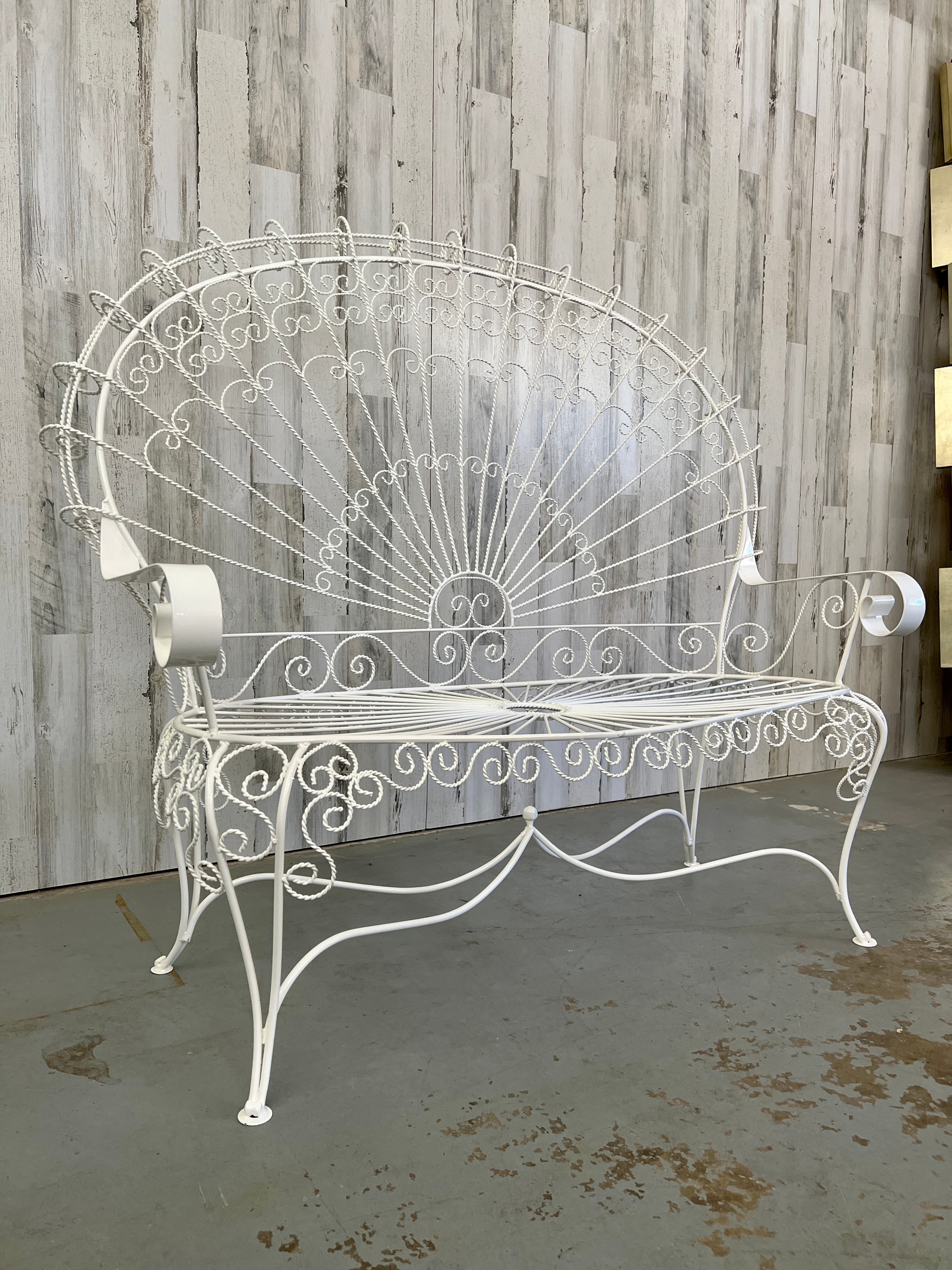 Vintage iron peacock settee. Recently powder coated. Features detailed and beautiful wirework. Perfect for a patio or garden setting.