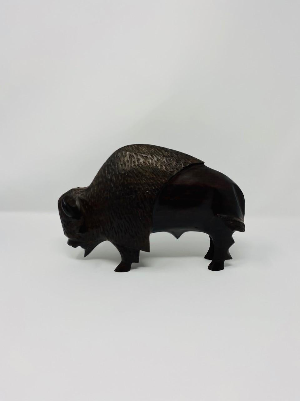 Vintage and beautifully carved buffalo sculpture. Meticulously carved and etched resulting in an amazingly smooth and hard finish achieved with no lacquer or varnish. Due to its extreme density, it is resistant to water, scratches and stains. The