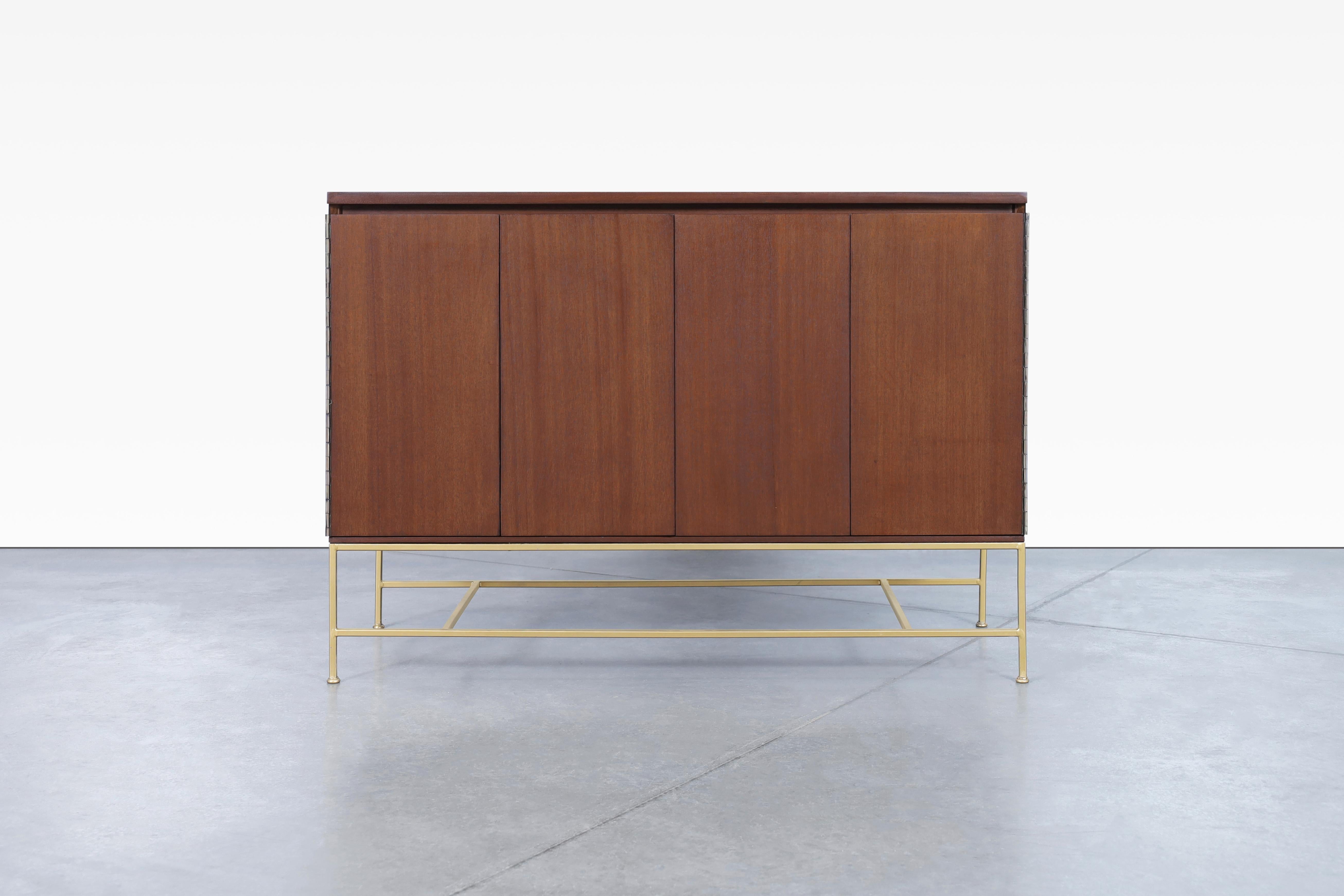 Beautiful vintage “Irwin Collection” mahogany and brass credenza by Paul McCobb for Calvin Furniture, manufactured in the United States, circa 1950s. This piece is a true representation of McCobb's renowned craftsmanship. Meticulously refinished to
