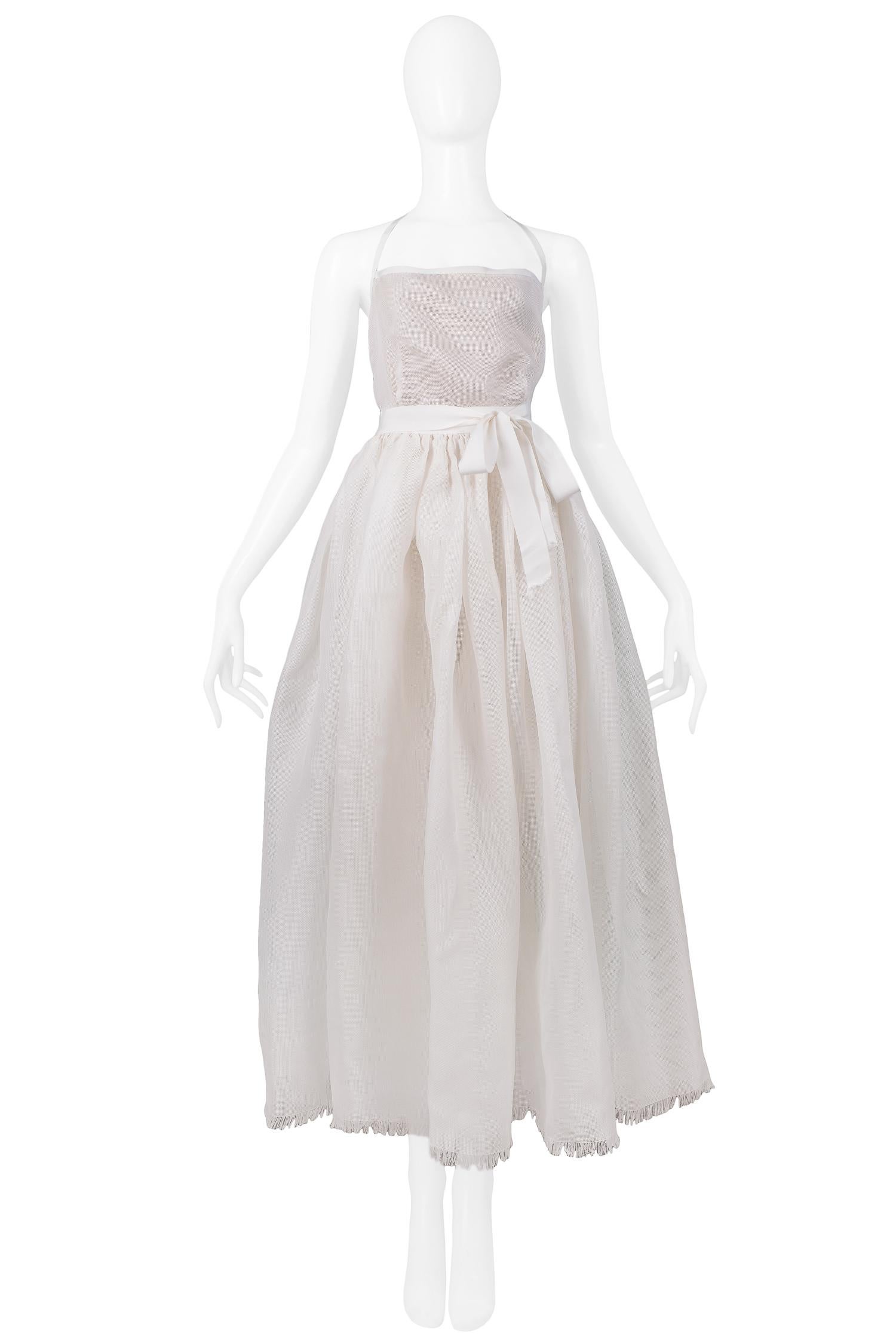 Vintage Isaac Mizrahi off-white silk gazar evening gown. Features a full wrap-around skirt, halter neck, open back, and fringe detail at hem.

Excellent Vintage Condition.

Size: Petite