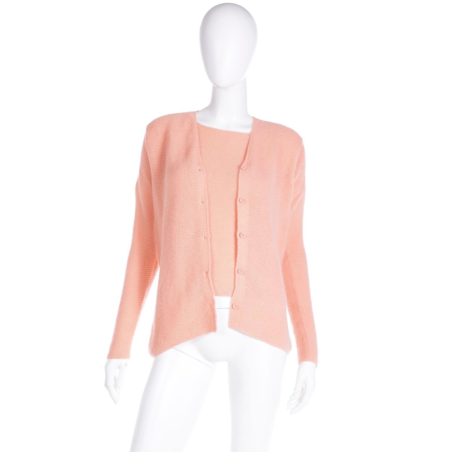 This lovely vintage Isaac Mizrahi peach cashmere sweater twin set includes a button front cardigan and a short sleeve pullover top. Of course, you can wear the set together, or you can wear each piece on its own. We love the luxurious feel of the