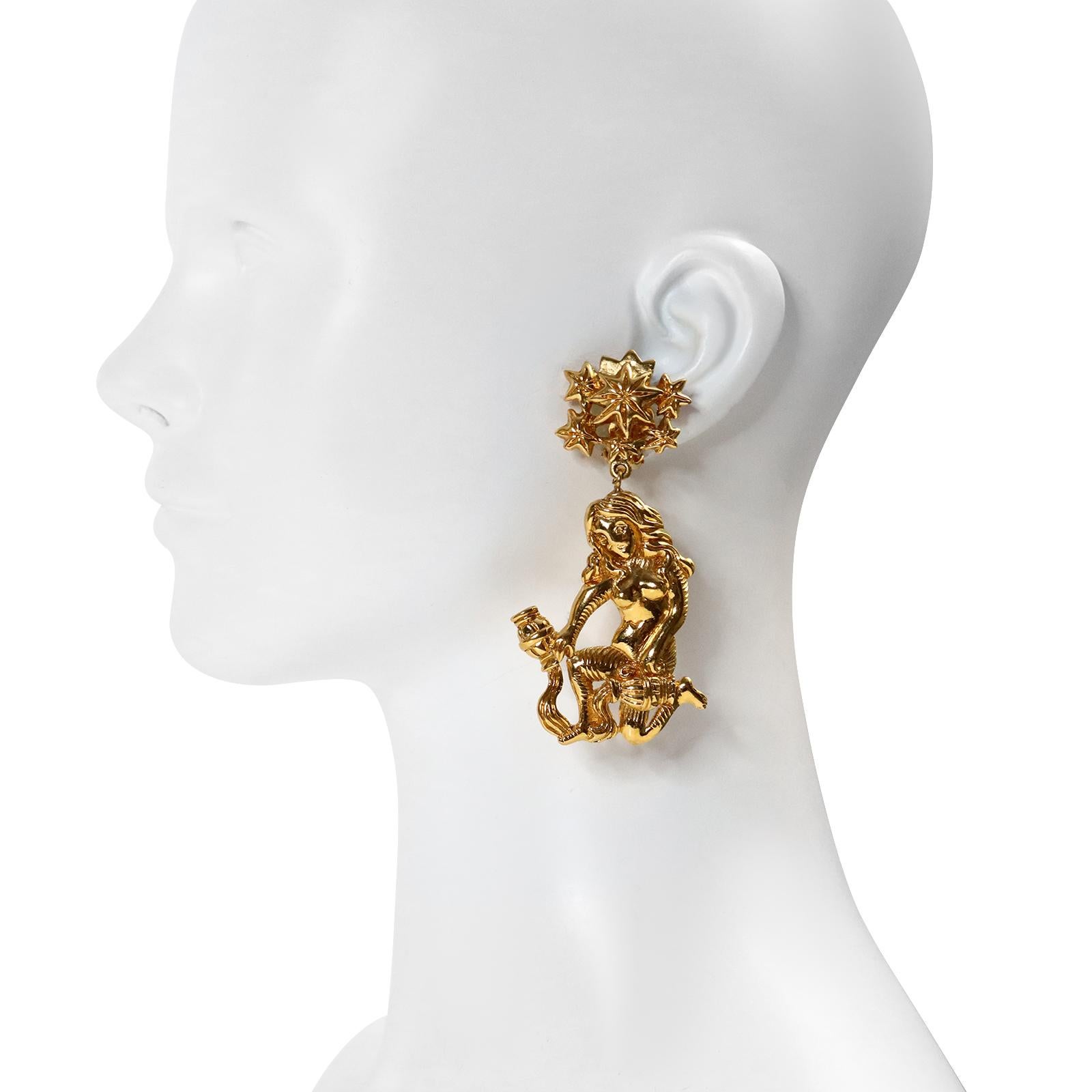 Vintage Isabel Canovas Gold Dangling Girl Earrings Circa 1980s. These are so special. She is kneeling with what appears to be two urns. She could be a mythical creature. Clip On. 

 I will be happy to send you velcro dots to wear with these if you