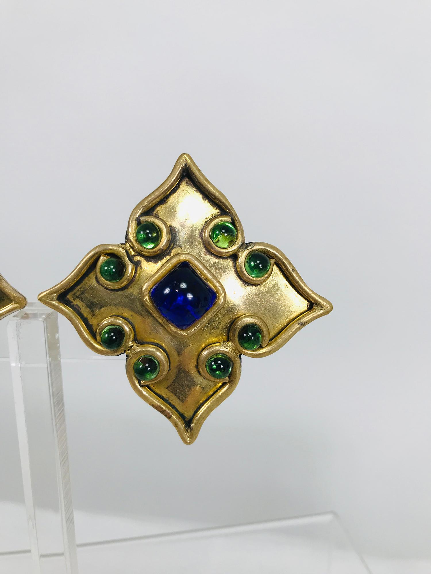 Vintage Isabel Canovas handmade goldtone Moorish jewel earrings from the 1990s. Beautiful earrings in a star shape with raised work and bezel set cabochon coloured glass stones the small stones are green and the center stone is blue. Clip back.