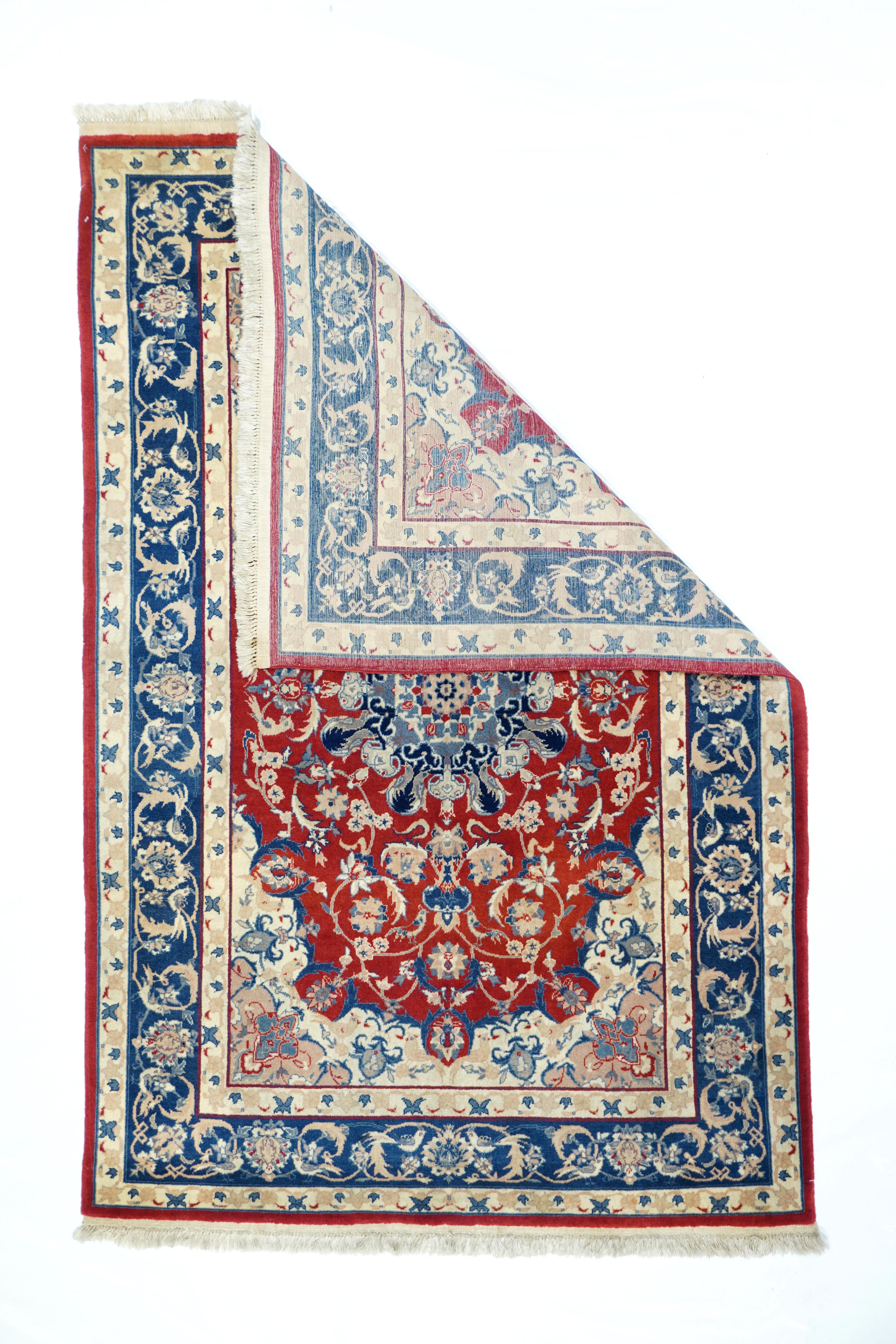 Vintage Isfahan rug¬†4' x 6'. The saturated red field features a variety of sickle, lancet and saz leaves, along with rosette groups, palmettes and small birds, all enclosing a teal and navy round medallion with cloud bands, around a cream central