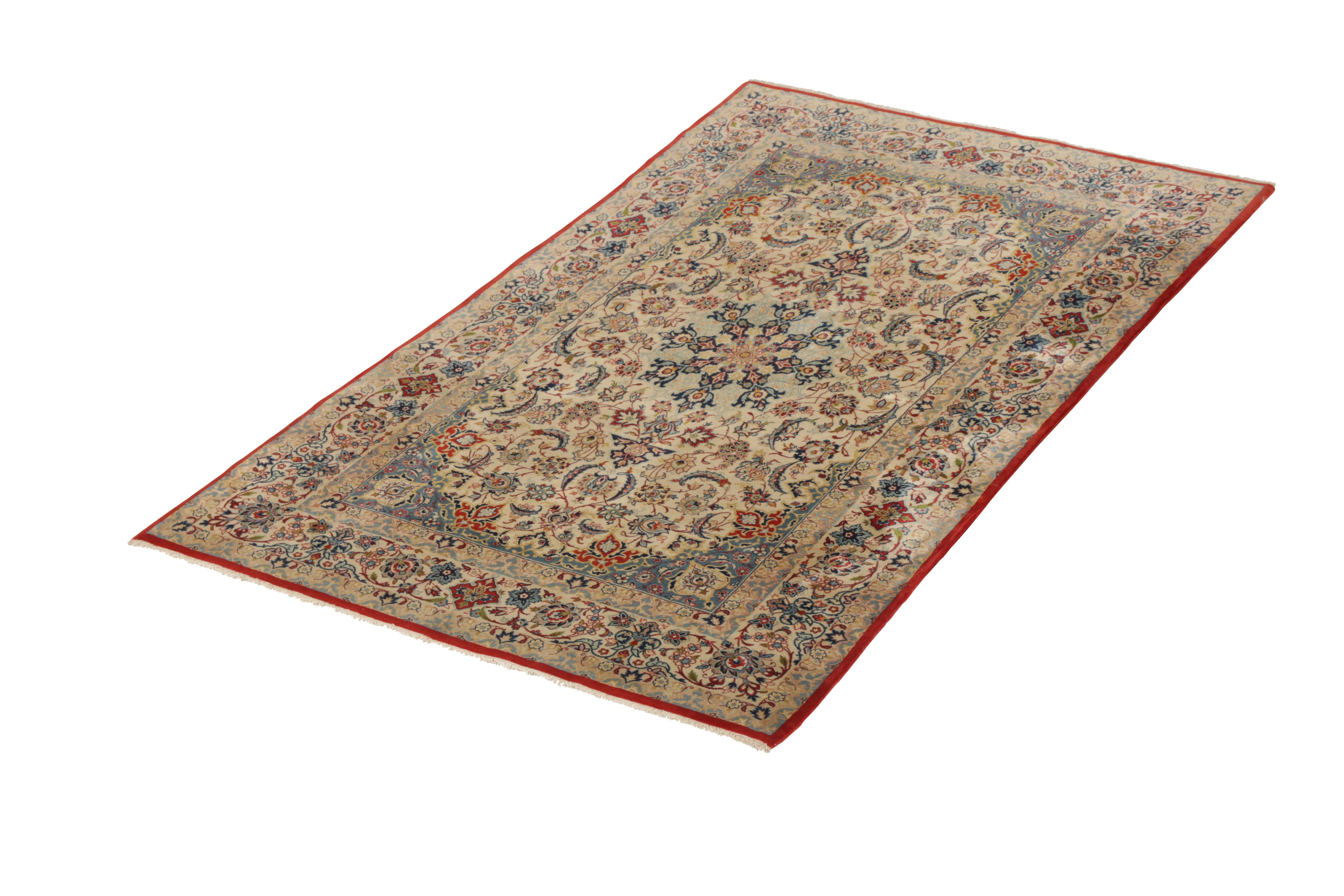 Hand knotted in a luxurious wool and sheen silk originating circa 1950-1960, this vintage Persian rug connotes a midcentury Isfahan rug style, celebrated among the traditional Persian rug styles for intricacy and grandeur like that of this married