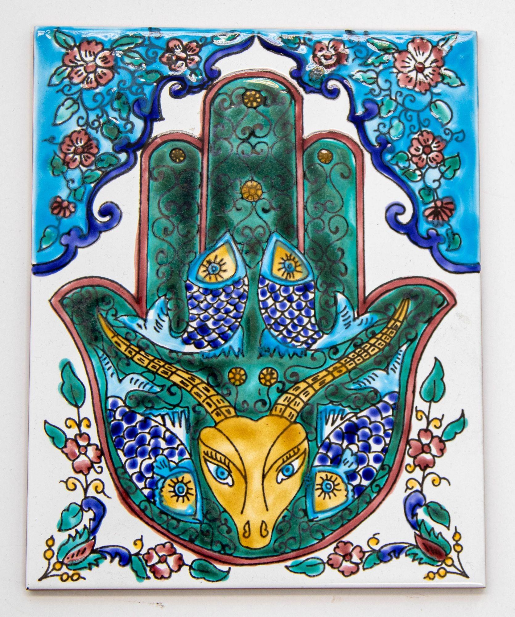 Vintage Islamic Moroccan tile with the Hand of Fatima, pair of Fishes and a Gazelle, the Hand of Fatima is here to protect against negative energy, fishes and the gazelle are to bring good energy for business and wealth homes.
The Hand of Fatima,