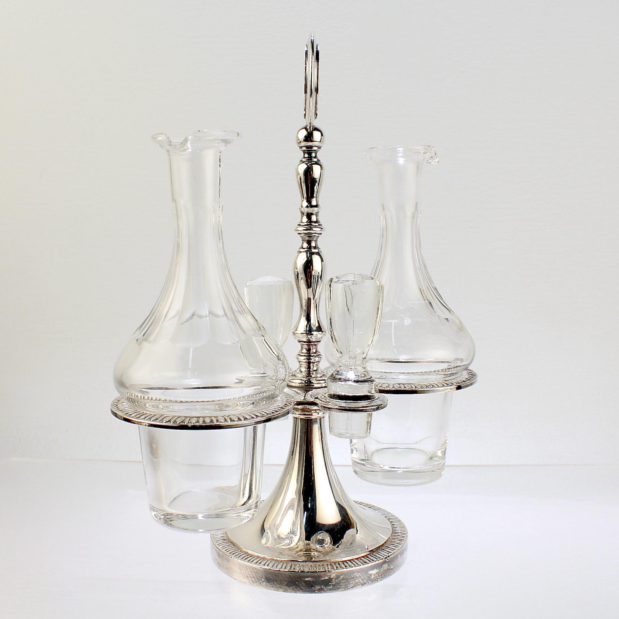 A fine silver plate and crystal cruet set.

By Israel Freeman.

Consisting of 2 cut glass bottles with conforming stoppers and a silver plated base with a rotating holder for the bottles.

Simply a wonderful cruet stand! 

Date:
20th