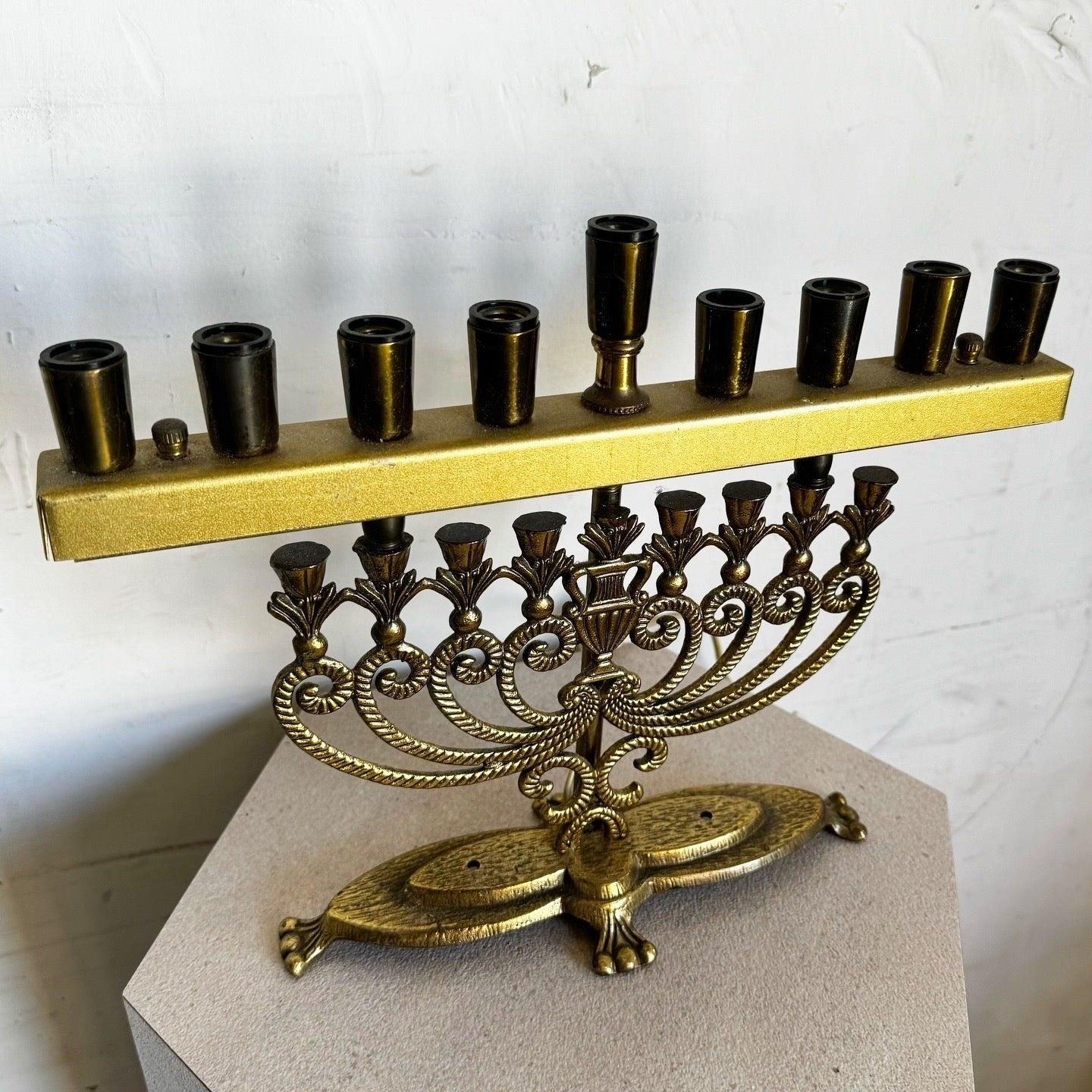 Vintage Israeli Brass Menorah Lamp with ornate scrollwork, floral details, and functional design. Perfect for Hanukkah or year-round display.
 
 Lightbulbs are not included. 
 
 We sell items as acquired, without restoring or repairing. Vintage